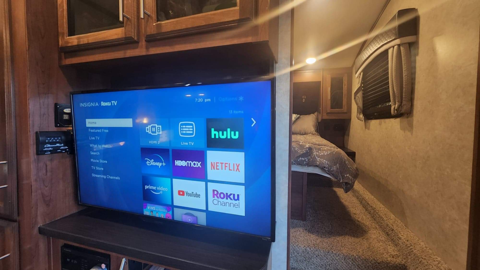 RV rental interior featuring an Insignia Roku TV with streaming apps (Netflix, Hulu, Disney+) and a cozy bedroom view.. Jayco Eagle HT 2018