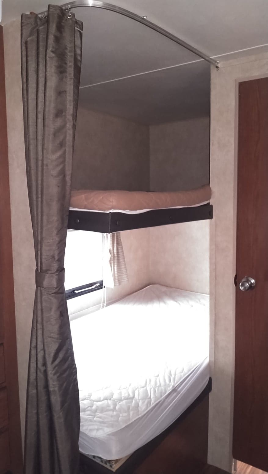 RV rental: view of functional bunk beds with mattresses & a privacy curtain in the compact sleeping area.. Forest River Salem 2015