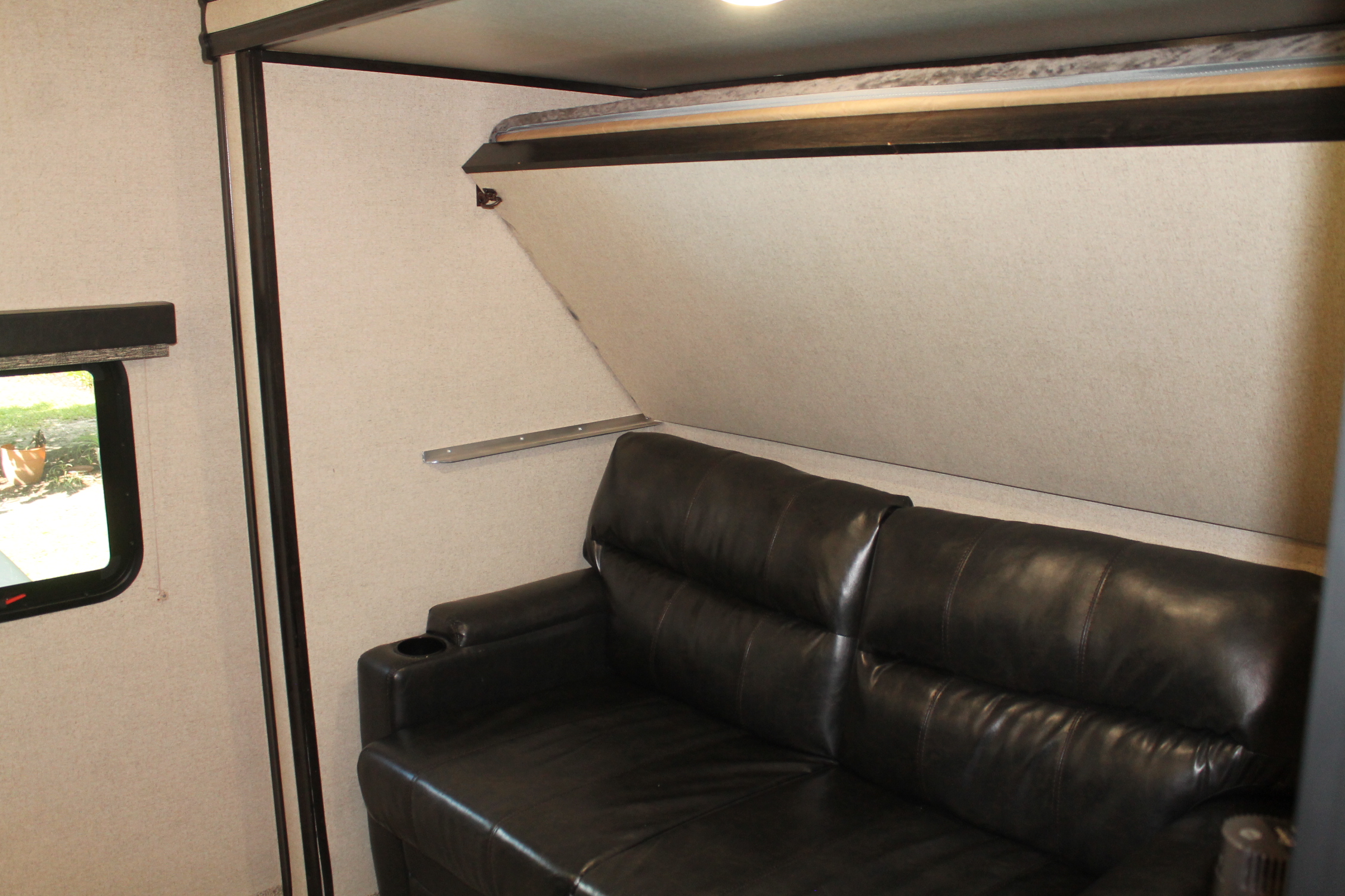 RV rental: Compact interior with a comfy black leather sofa and pull-down bunk bed, maximizing sleeping space for travelers.. Coachmen Spirit Ultralight 2020
