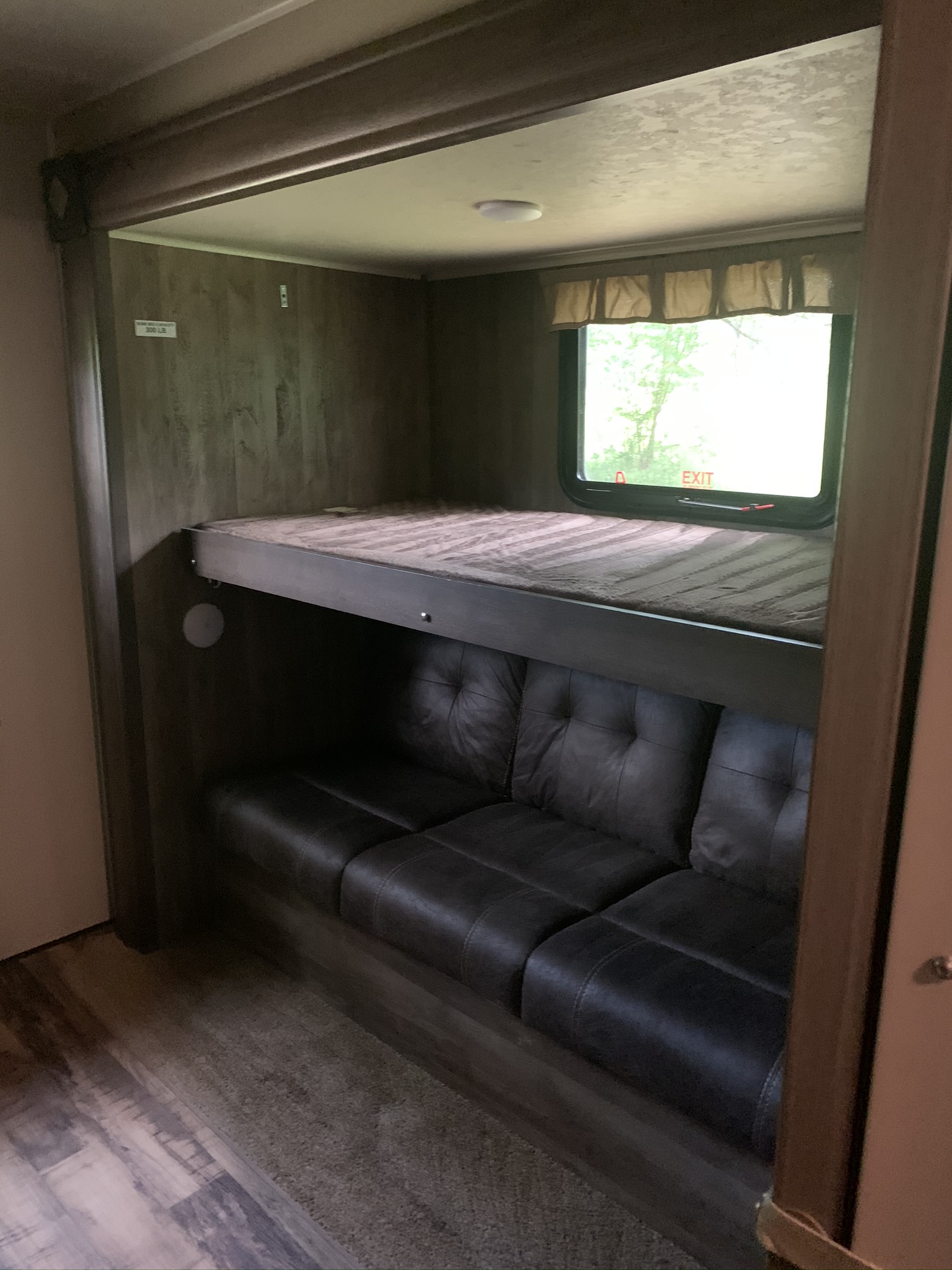 RV rental: Upper bunk bed with mattress above a convertible sofa and window. Functional family sleeping.. Forest River Palomino Puma 2017