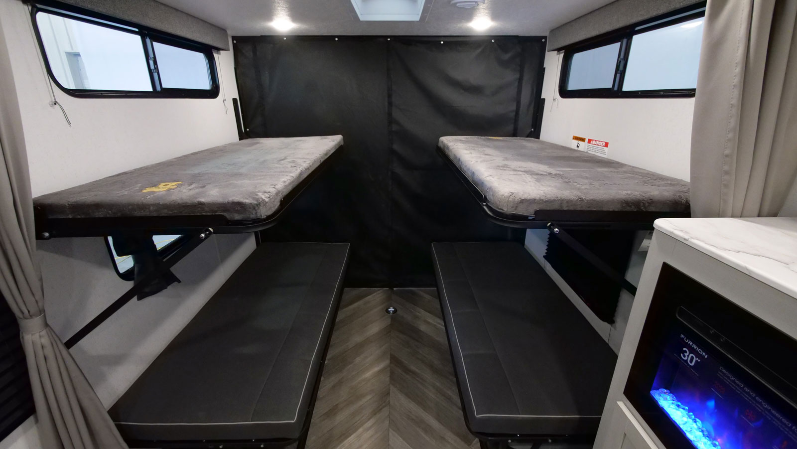 RV rental: Rear bunk beds and bench seating provide versatile sleeping/cargo space in this modern interior.. Forest River Wildwood 2022