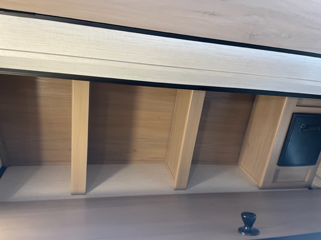 RV rental overhead storage: light wood compartments, control panel. Clean interior for travel.. Cruiser Rv Corp Radiance 2022