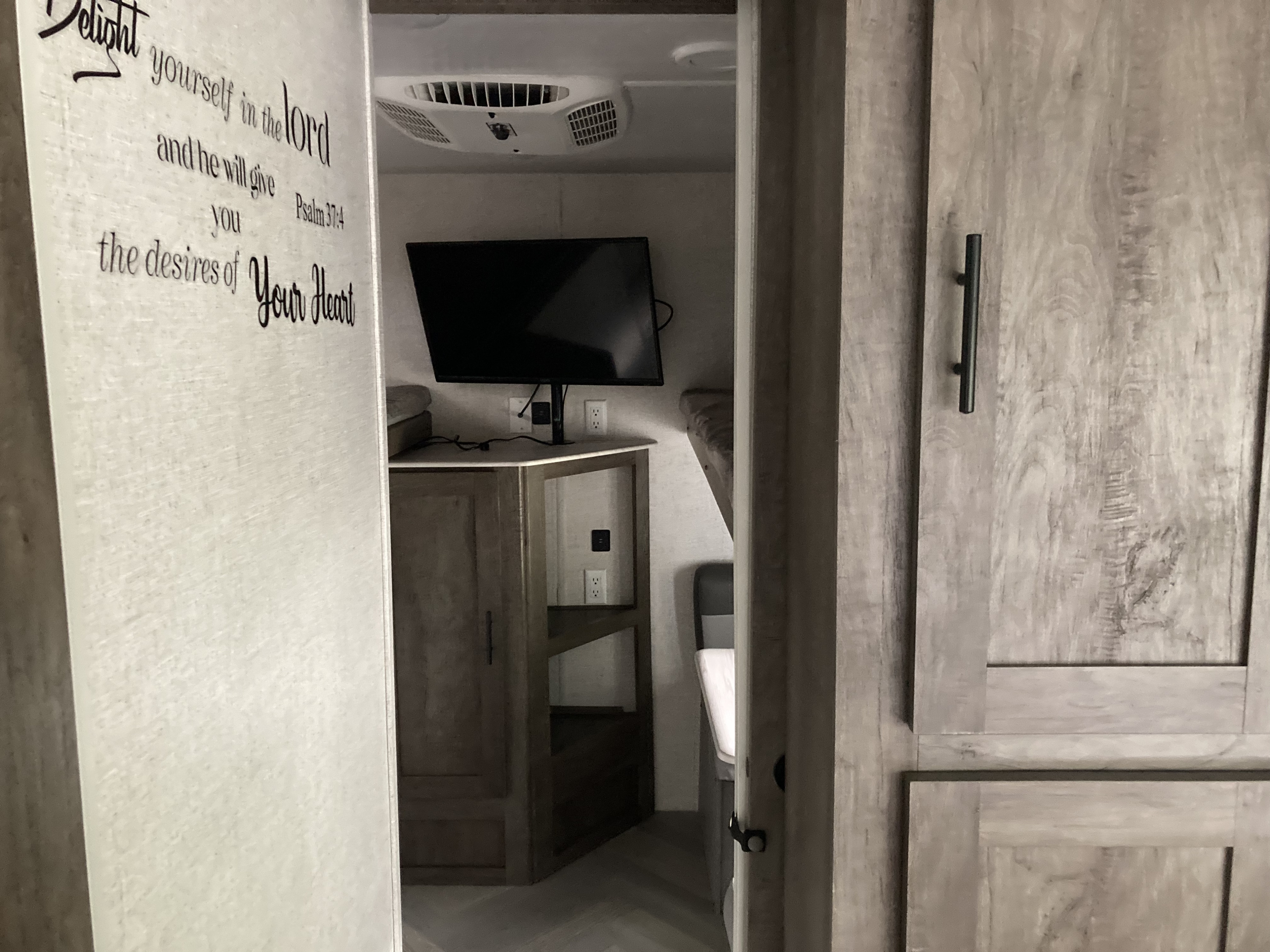 This room includes 3 beds, 1 sitting area with a table, and a tv.. Forest River Wildwood 2021