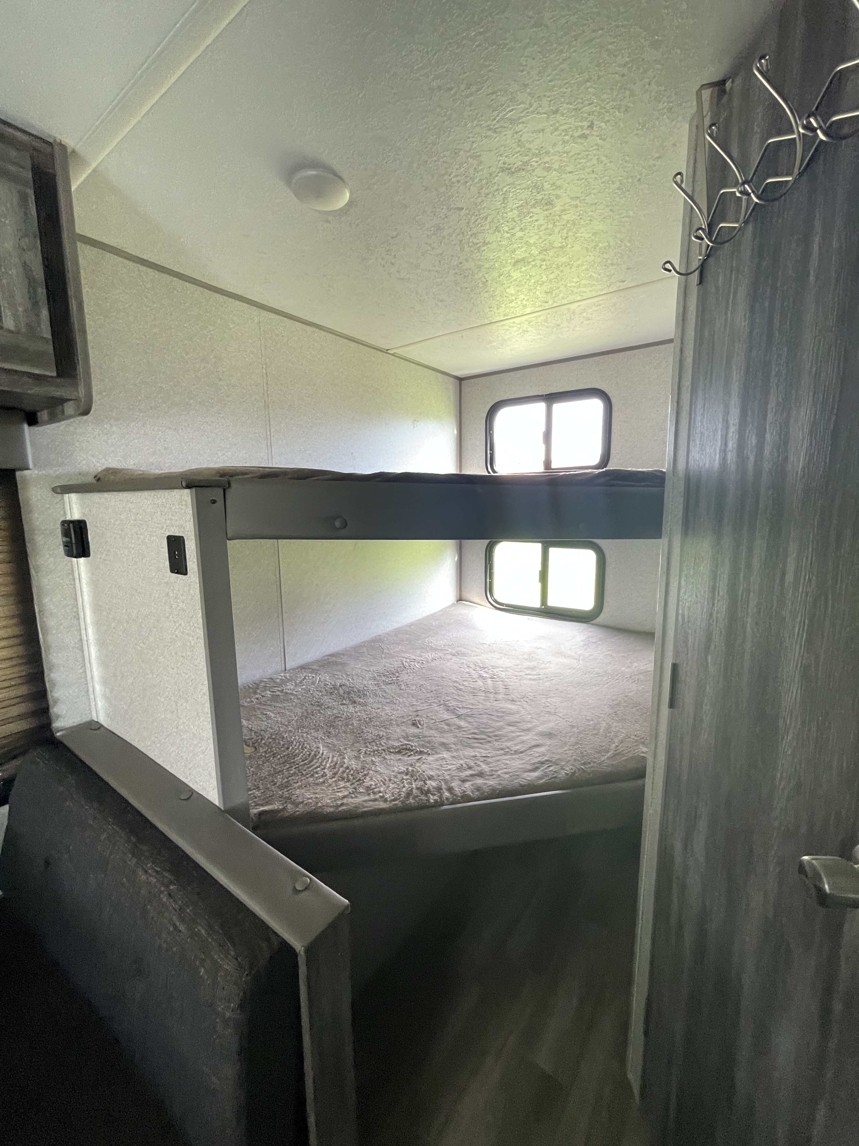 Cozy RV rental interior with bright bunk beds, perfect for family adventures. Light-filled sleeping area.. Forest River Salem FSX 2019