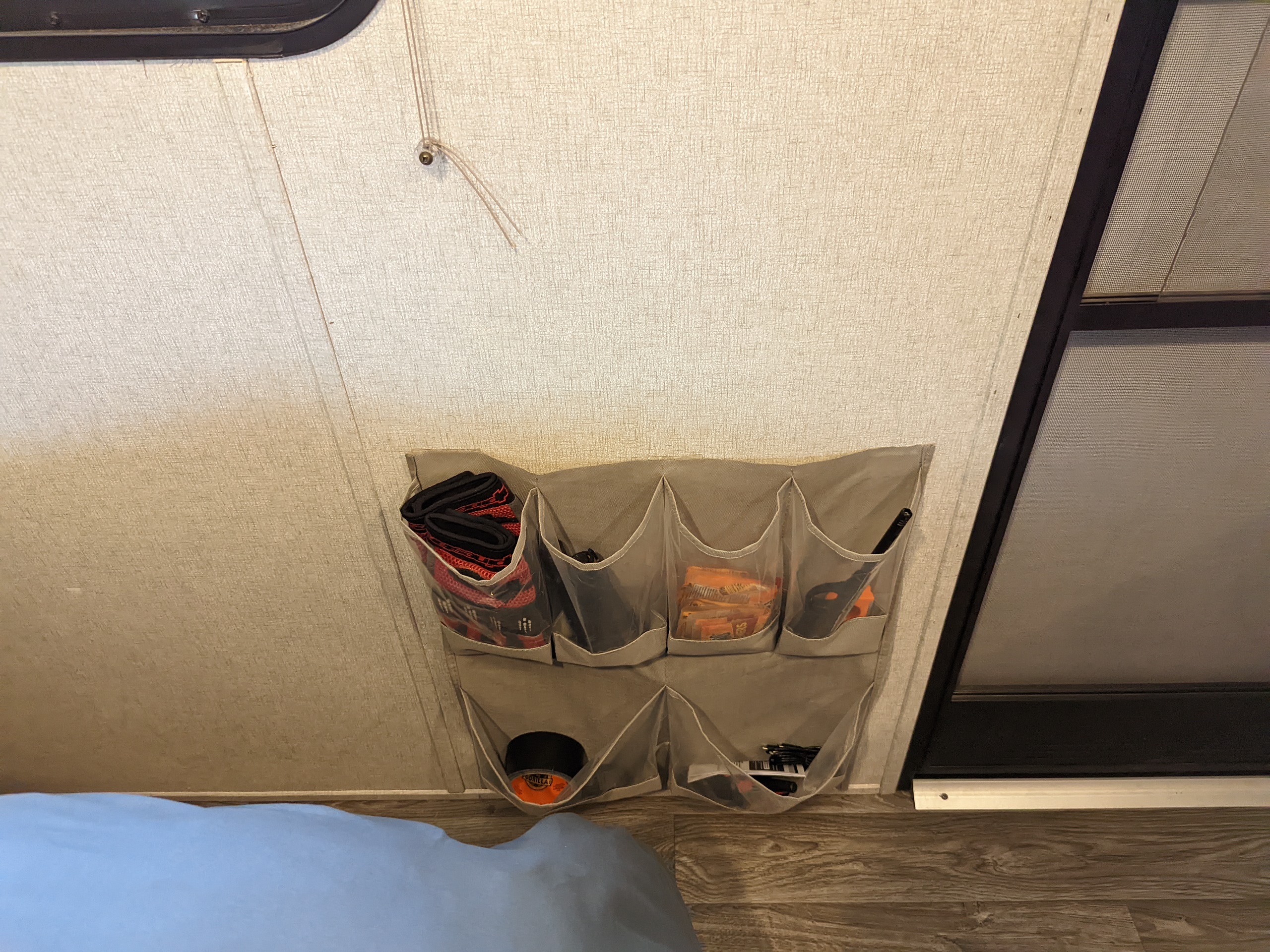 Stay organized in your RV rental! This wall-mounted organizer neatly stores gloves, tools, and cables above the bed.. Clipper Clipper Trailer 2019