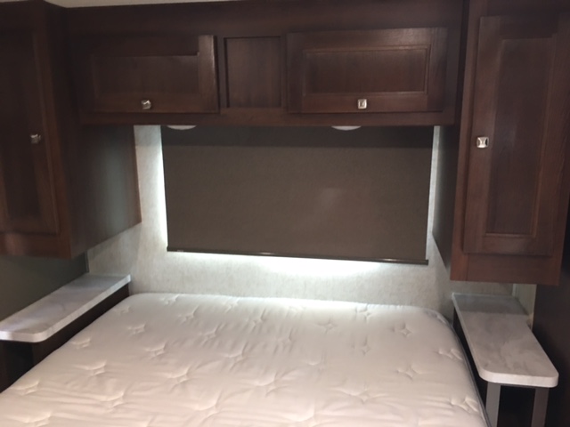 RV rental: Interior shot of a well-appointed bedroom featuring a large bed, ample overhead storage, and built-in nightstands.. Forest River Sunseeker LE 2019