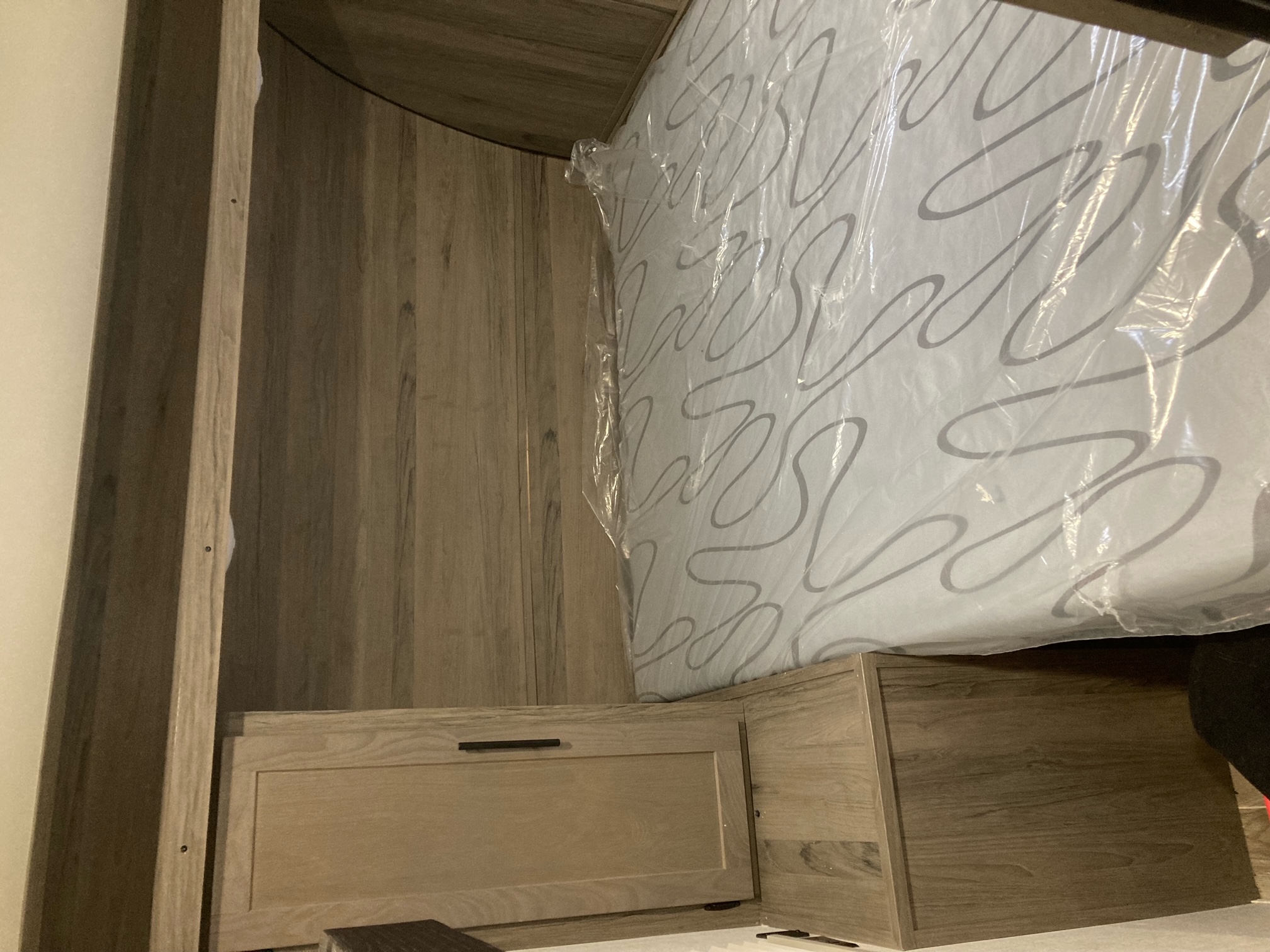 RV rental interior: New mattress in plastic on wood bed frame & storage unit. Ready for adventure.. Gulf Stream Kingsport 2021