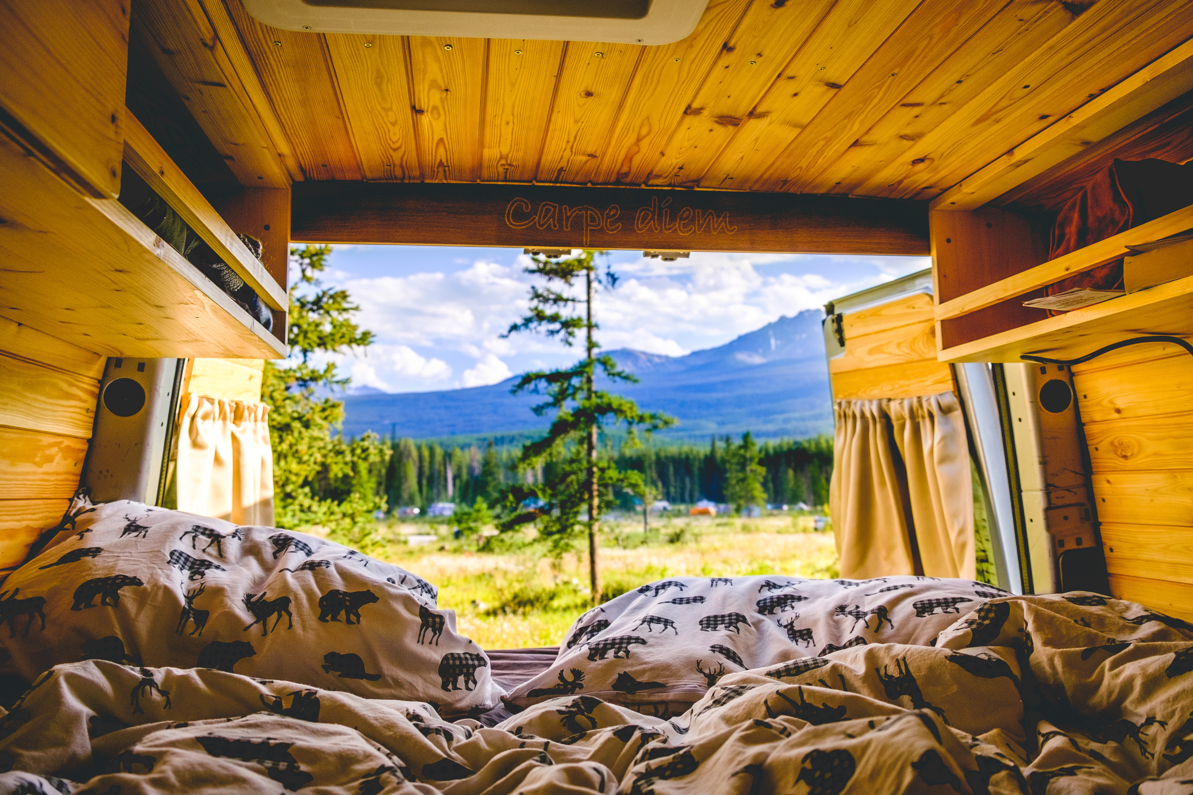 Cozy RV rental interior with "Carpe diem" carving, showcasing stunning mountain views and nature.. Mercedes-Benz Sprinter 2006