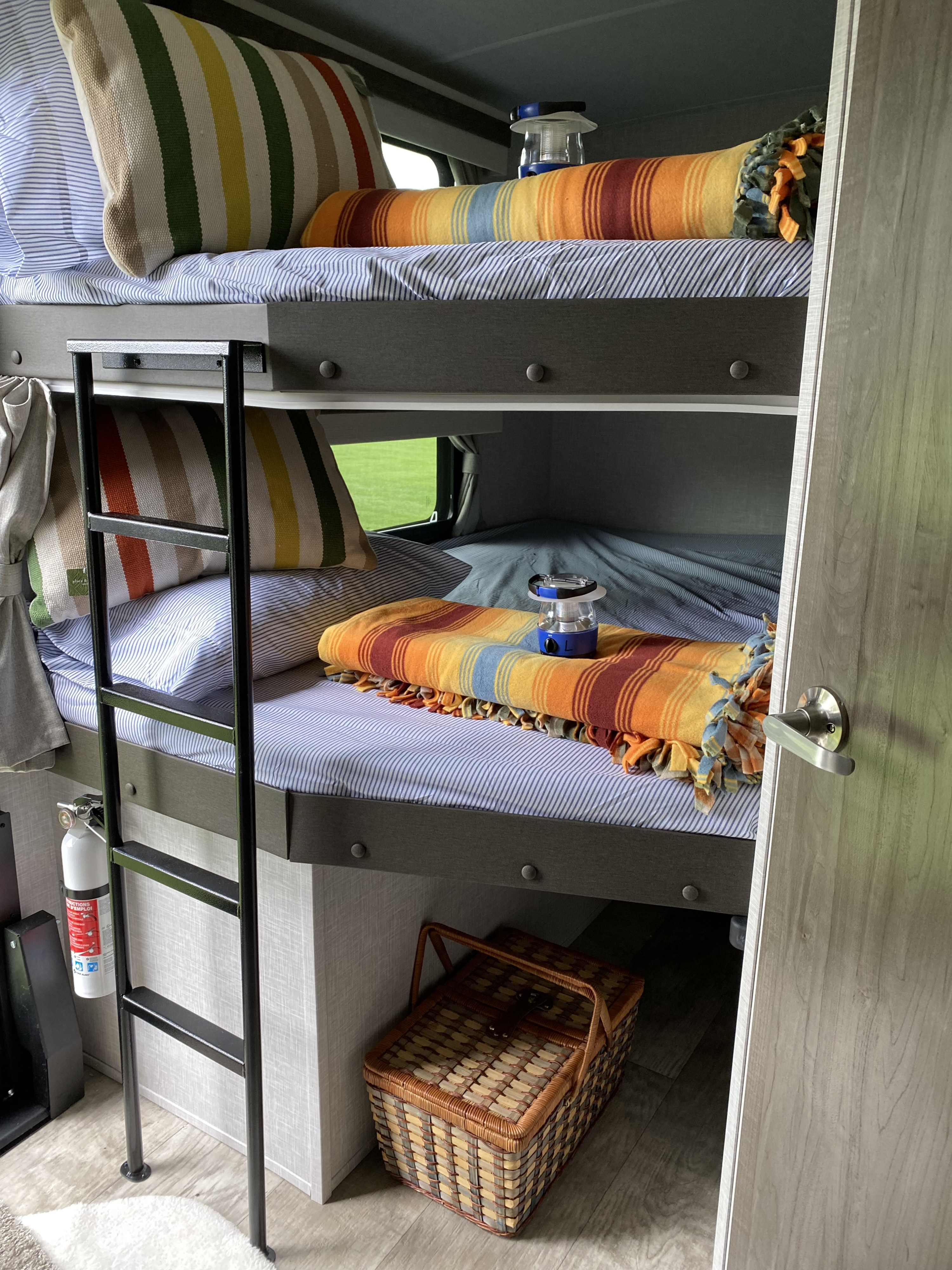 Double size bunkbeds with large open windows for viewing and personal airflow, individual USB ports, individual lighting, and privacy curtains.. Forest River Rockwood Ultra Lite Bunkhouse 2023