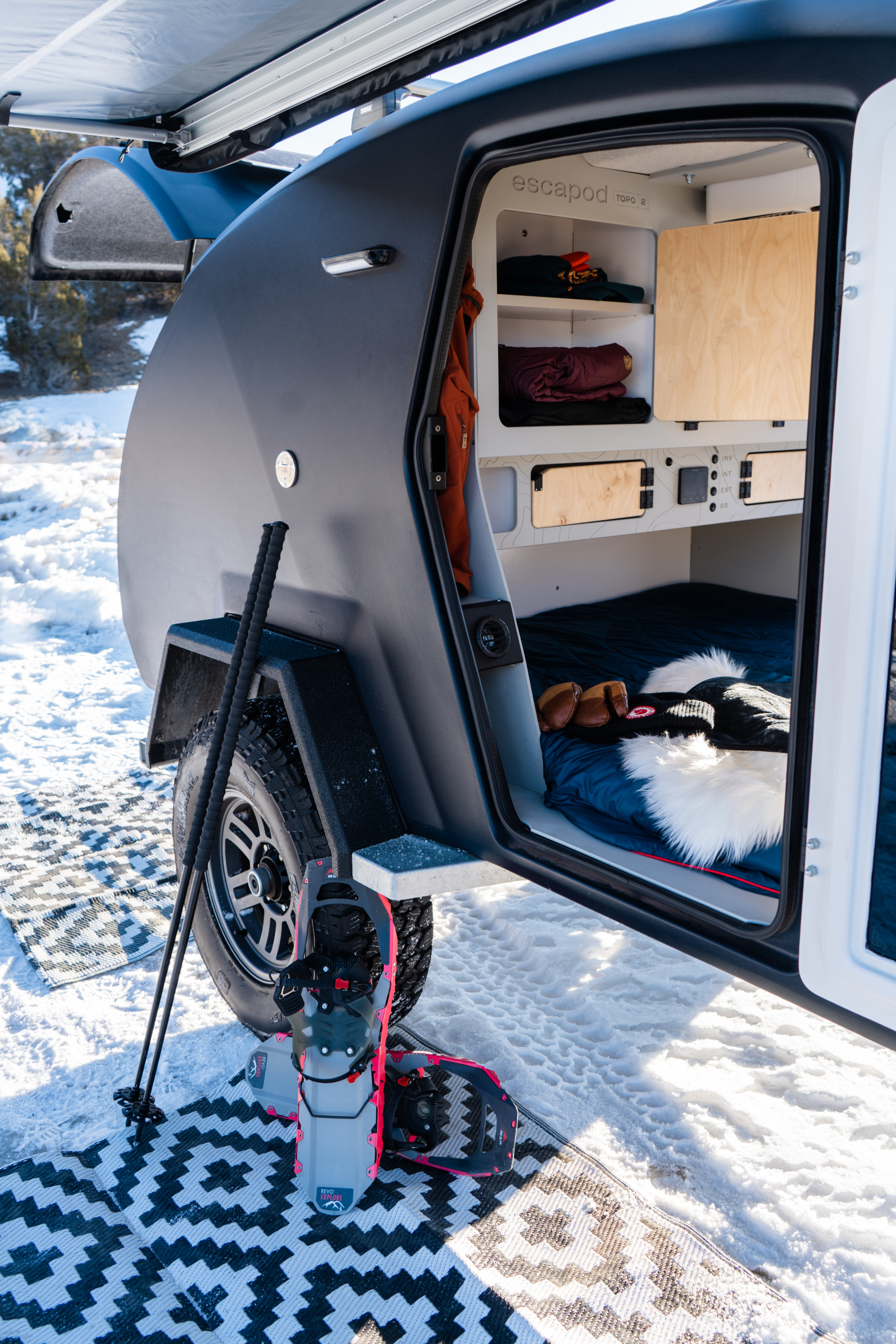 Explore winter with an RV rental: a compact escapod teardrop camper with its interior ready for adventure.. Escapod Topo 2 2023