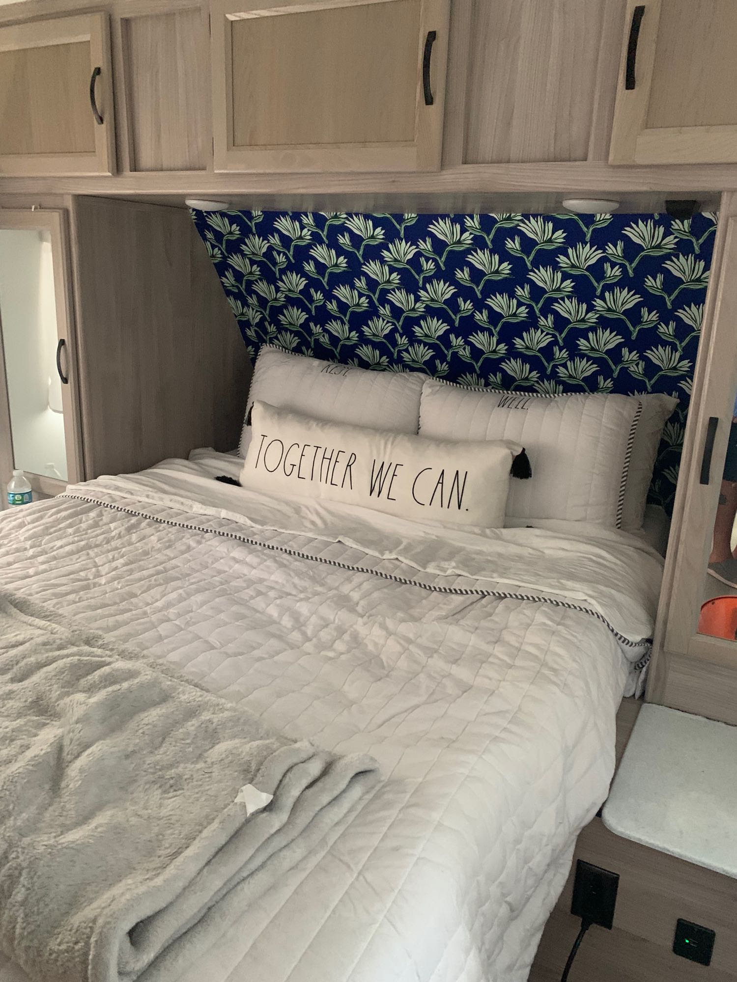 Queen size bed with storage above and on the sides ; a small tv on opposite wall with a full length mirror. Coachmen Spirit Ultra Light 2021