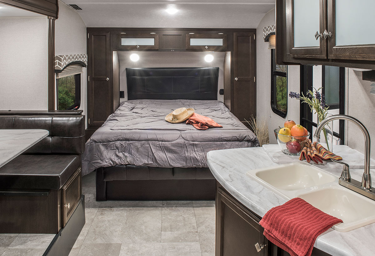 Spacious RV rental interior featuring a full bedroom, dinette, and functional kitchen.. Sonic Sonic Trailer 2018