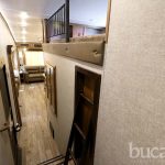 Bright RV rental interior from above. View shows a modern hallway leading to a living area, plus a cozy loft with ladder access.. Forest River Cherokee Sabre 2022