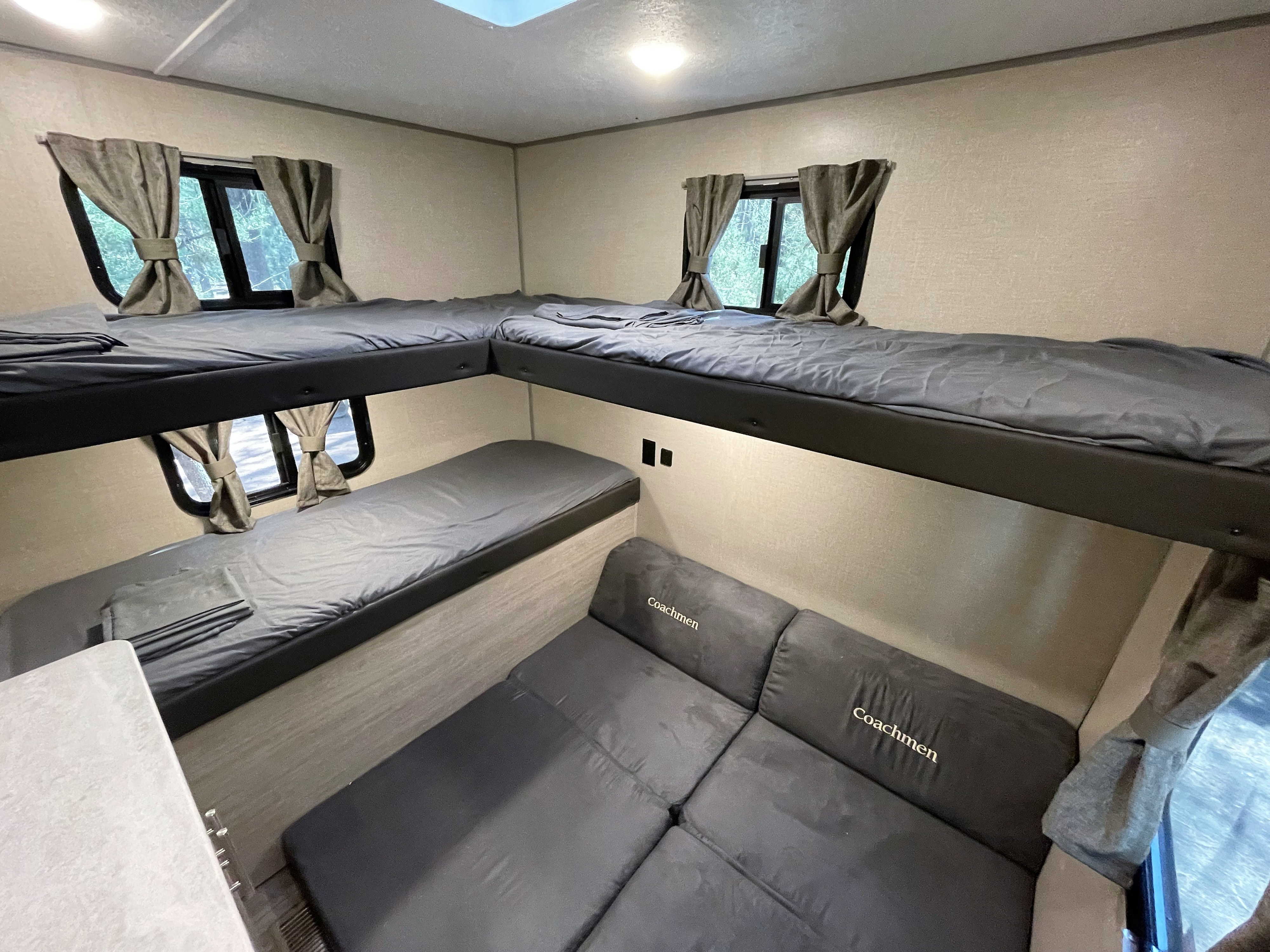 RV rental: Features L-shaped top bunks, a lower bed, and a Coachmen sofa, offering ample sleeping space.. Forest River Coachmen Catalina Legacy 2022