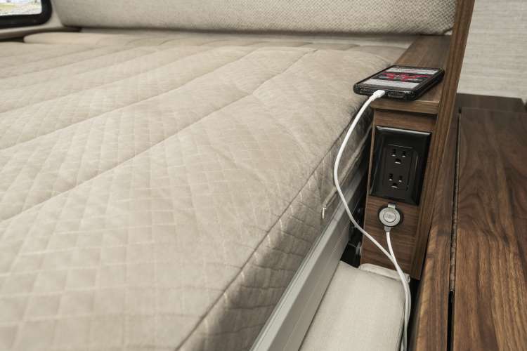 Comfortable RV rental bed with built-in power outlets (AC & USB) for convenient device charging.. Winnebago View 24D 2023