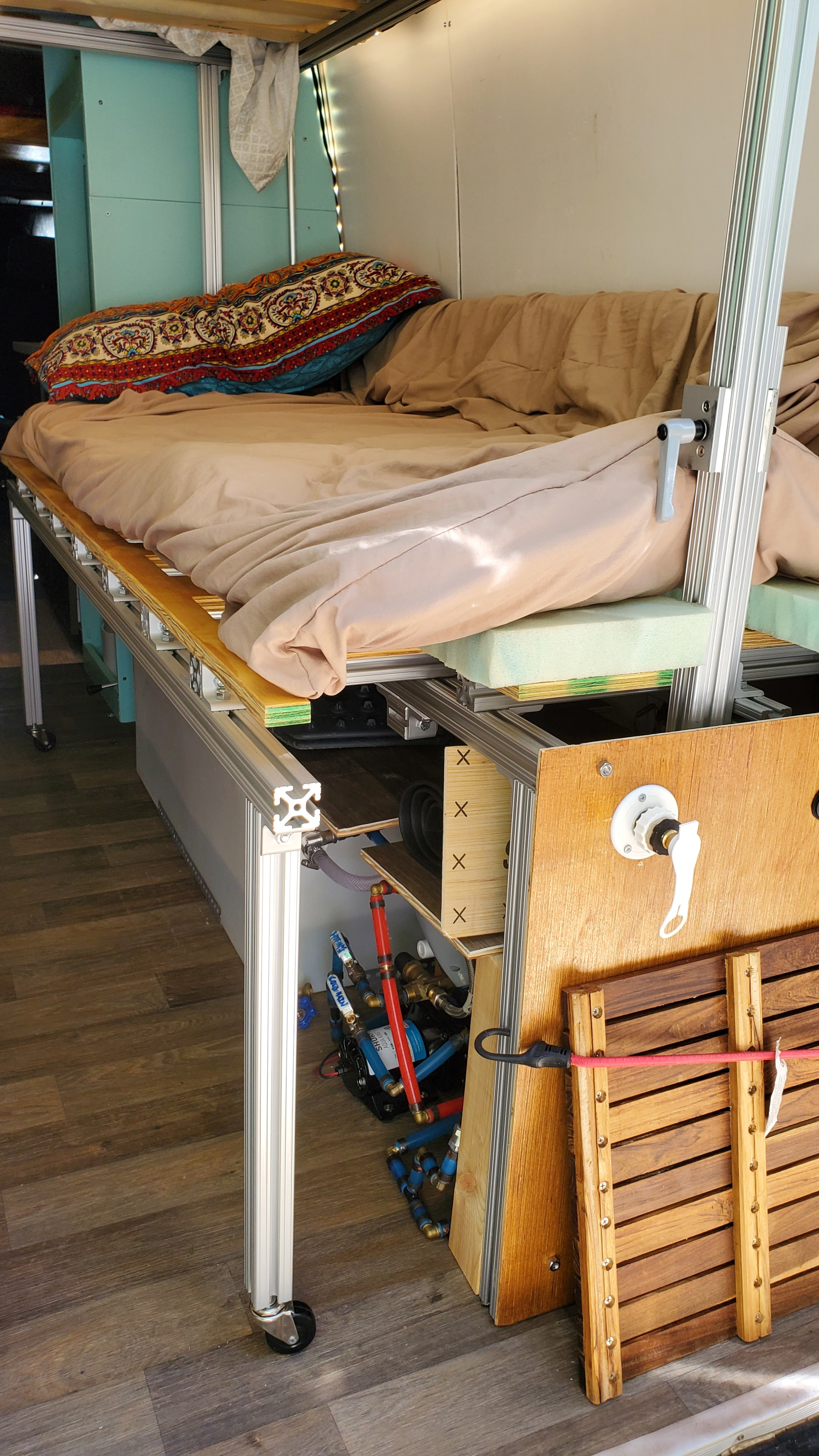 This RV rental's clever interior design features an adjustable bed platform built with aluminum, revealing plumbing & storage solutions.. Mercedes Benz Sprinter 2019