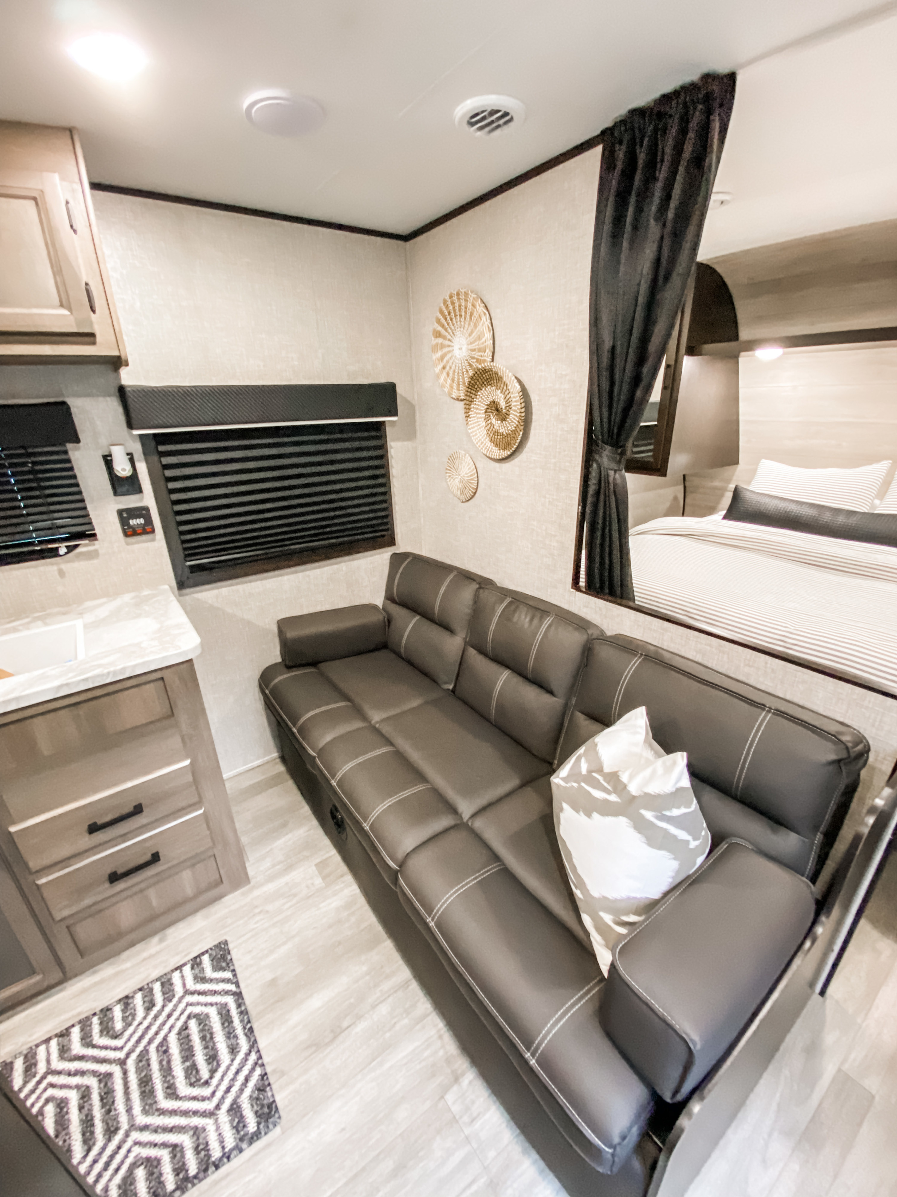 Experience comfort in this RV rental with a stylish sofa, compact kitchen, and private bed area, ideal for any adventure.. Jayco Jay Flight SLX 2022