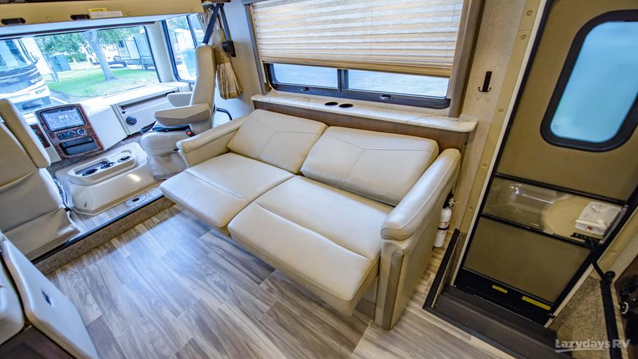 Spacious RV rental interior with a comfy sofa, cockpit area, and easy entrance, perfect for your next road trip adventure.. Thor A.C.E. 2020