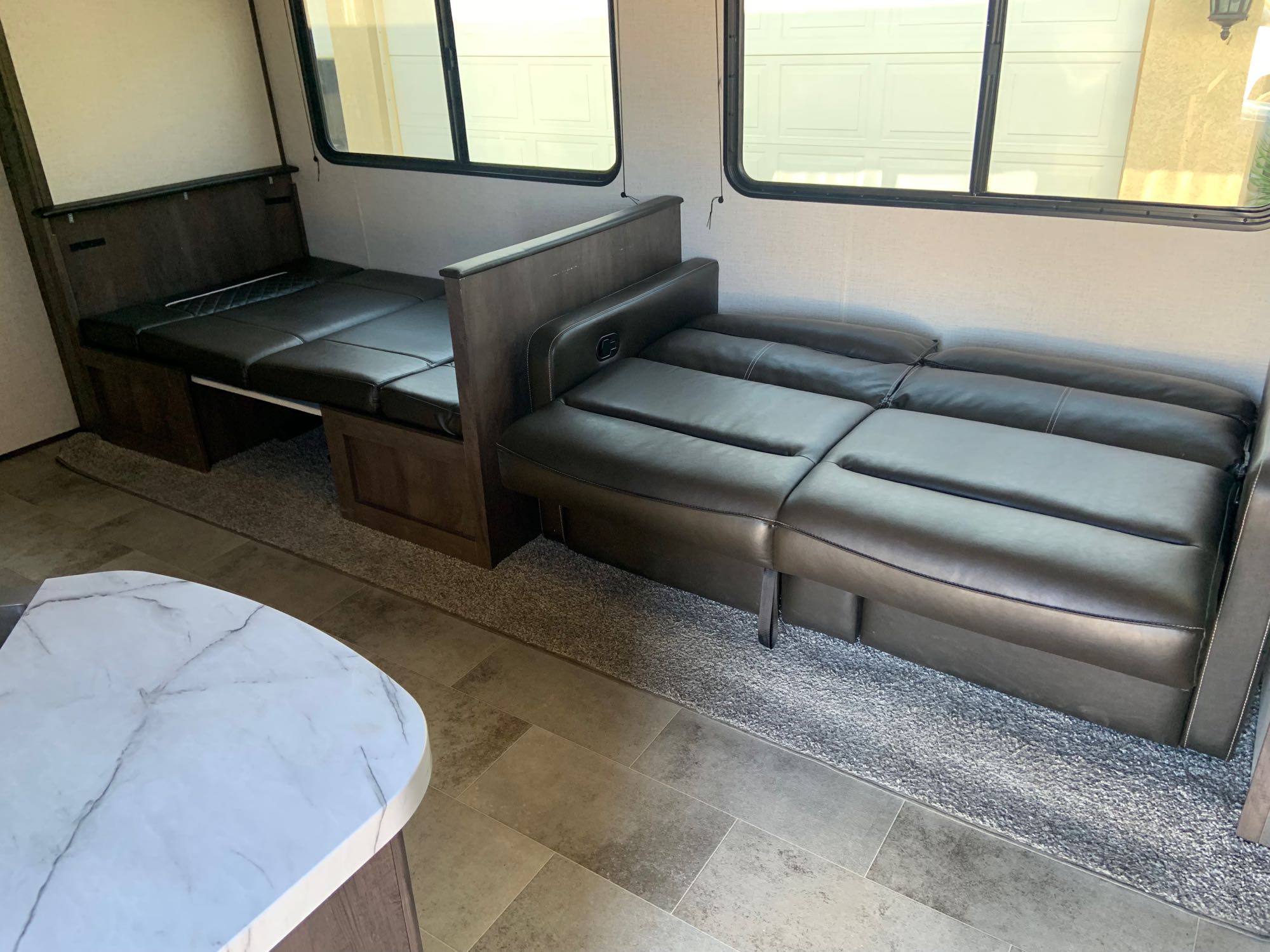 RV rental: Modern interior with dark leather convertible dinette/bed & sofa. Bright windows, mixed flooring.. Dutchmen Coleman Lantern 2021