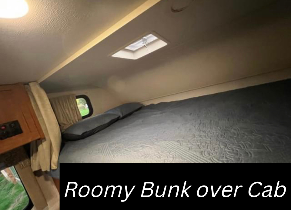 Inside an RV rental: a spacious cabover bunk with a large bed, two pillows, window, and roof vent for your comfort.. Winnebago Minnie Winnie 2017