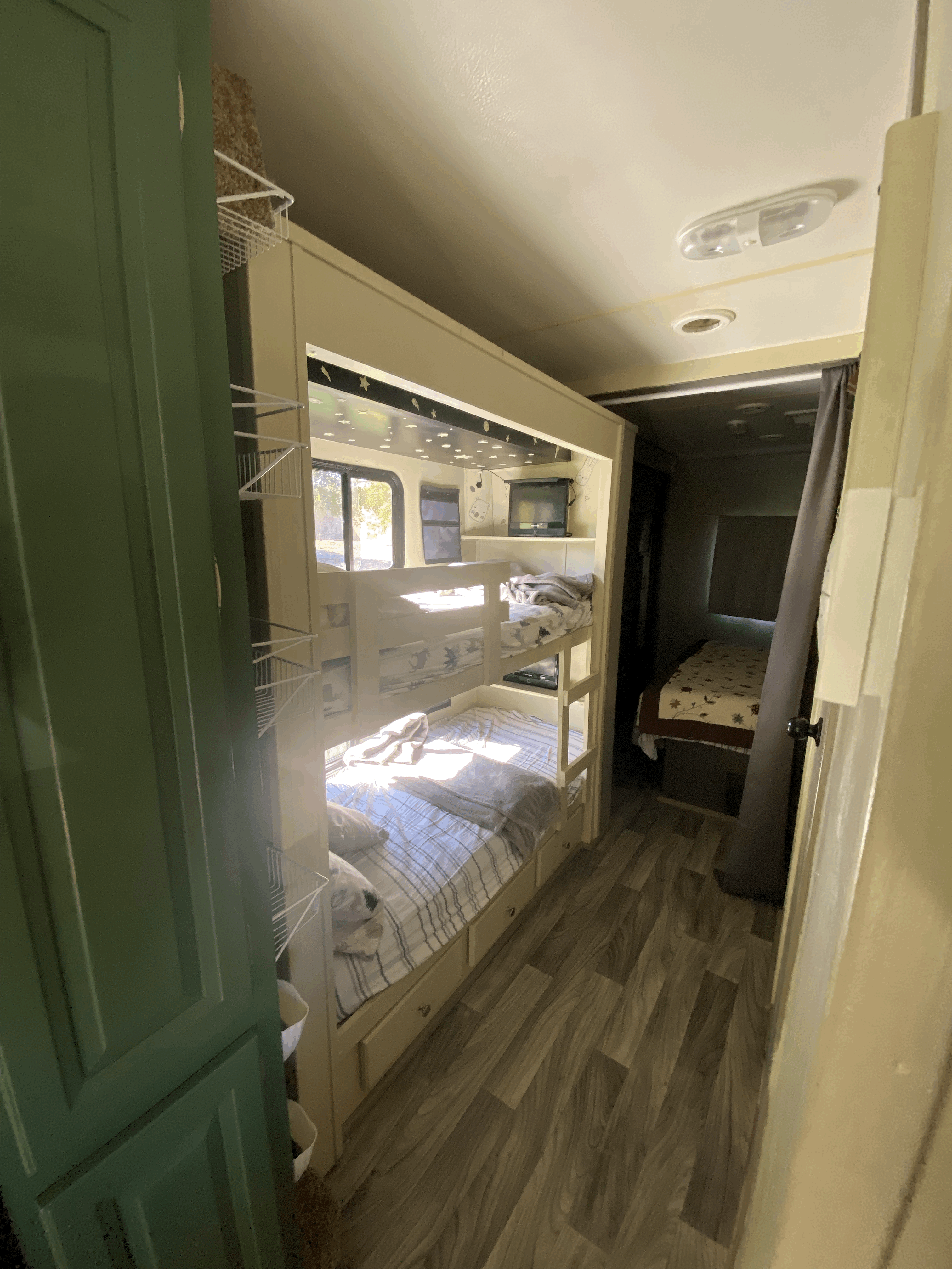 Compact comfort in this RV rental: built-in bunk beds with storage, a top bunk window, and a rear bedroom.. Forest River Georgetown 2011