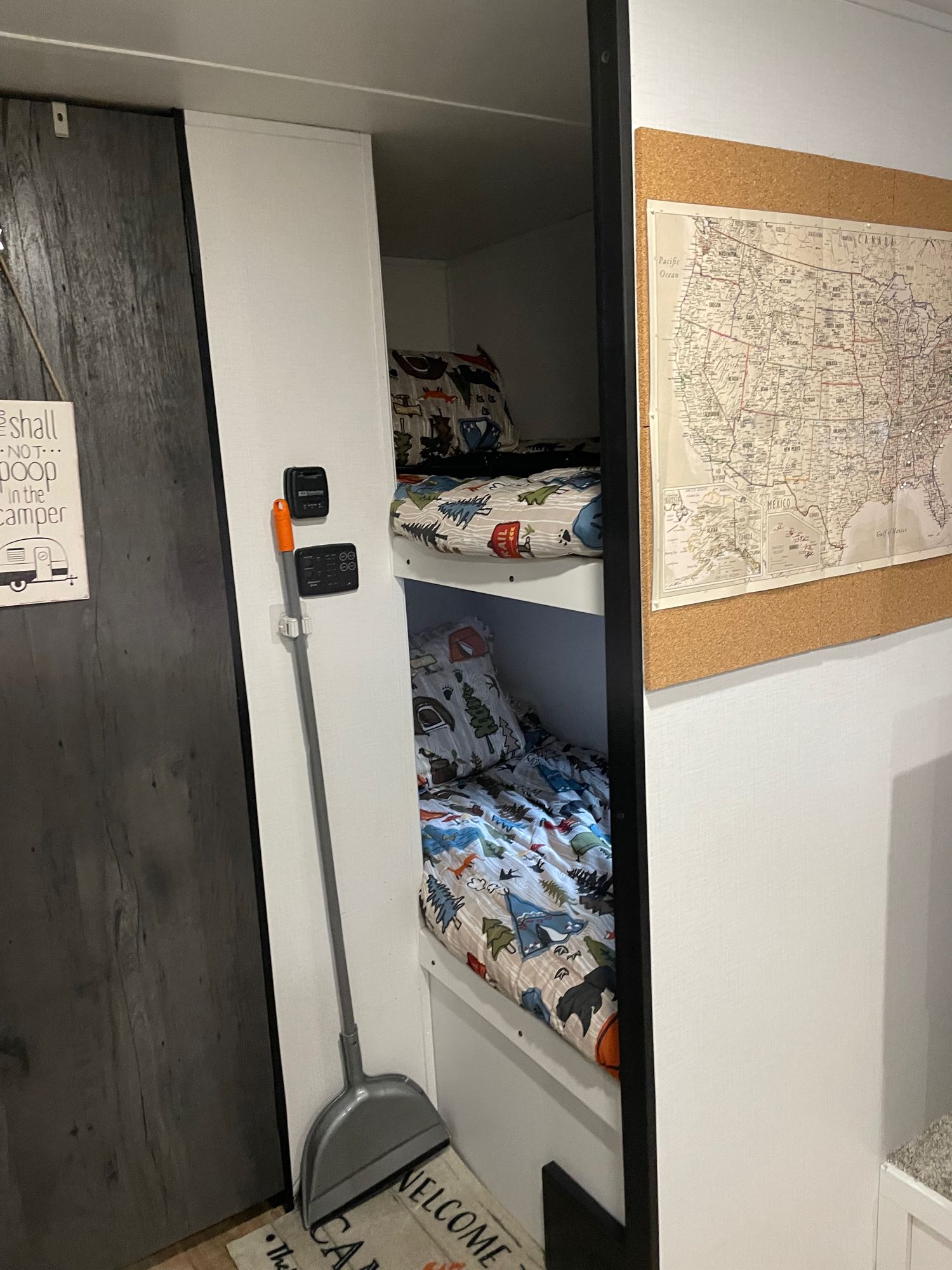 Cozy RV rental bunk beds with colorful camping bedding & US map. Compact living space equipped for travel.. Keystone RV Hideout 2022