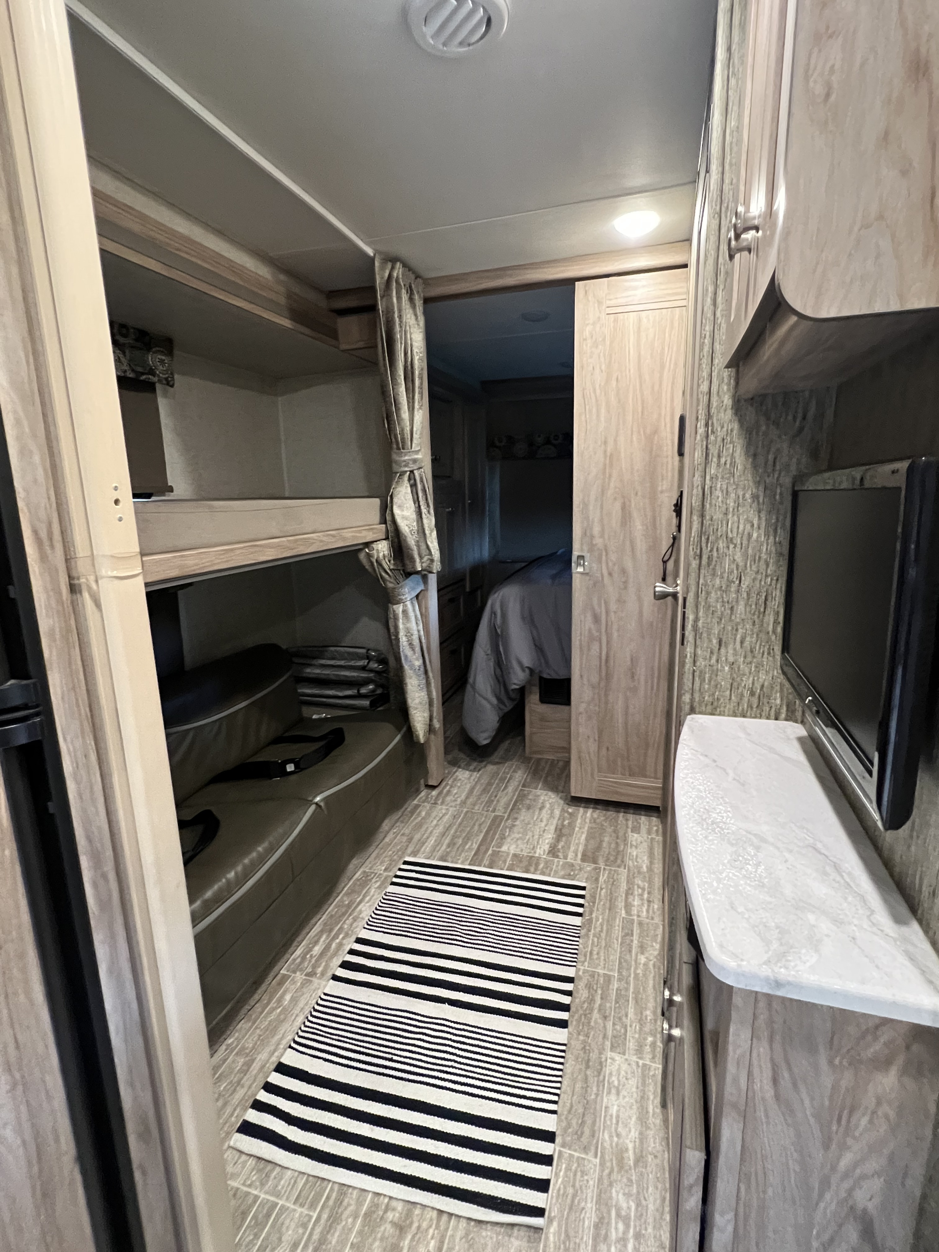 Bunk beds, with a small entertainment area. Forest River Sunseeker LE 2019