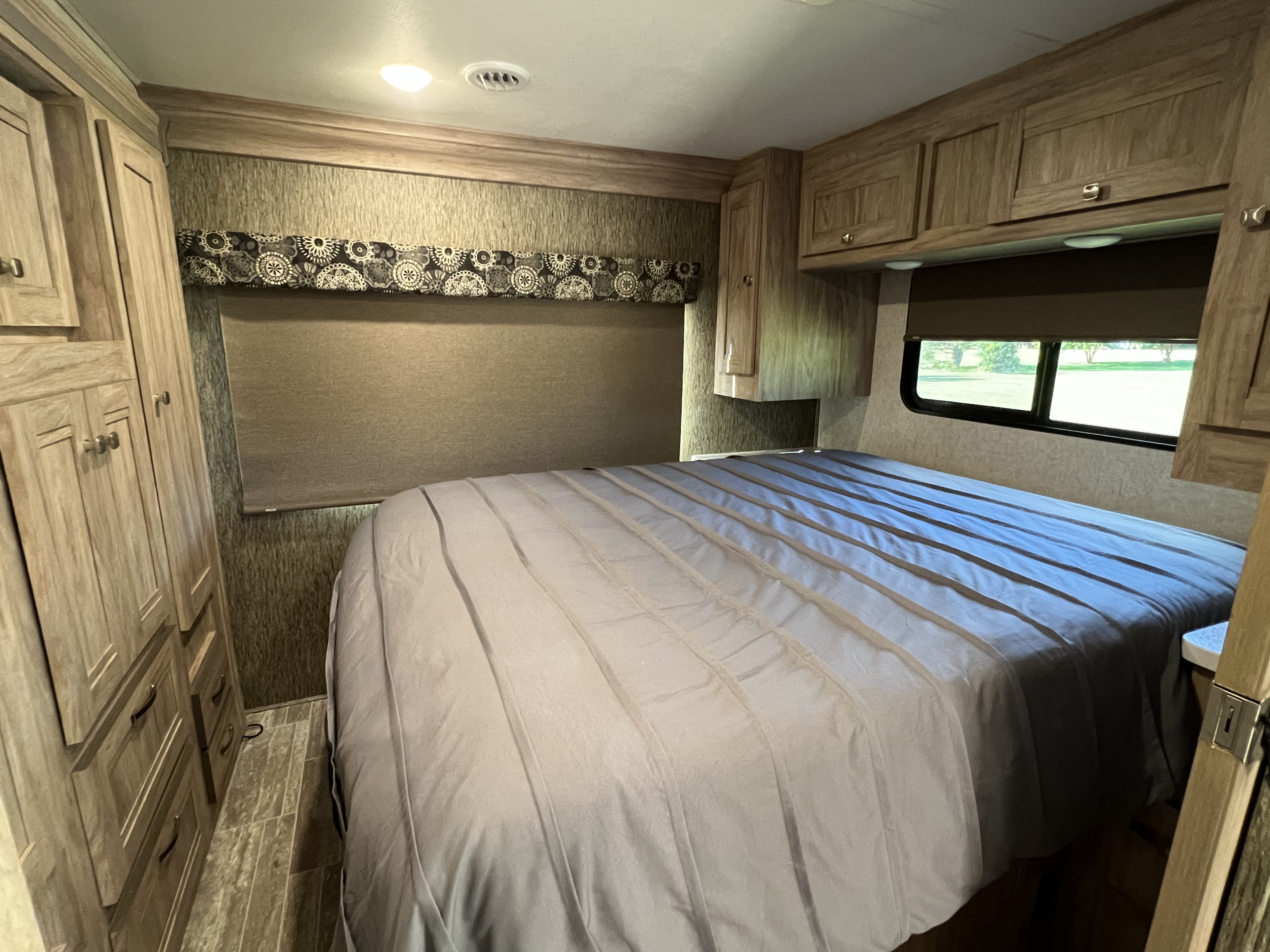 Primary sleeping area, with queen sized bed. Forest River Sunseeker LE 2019