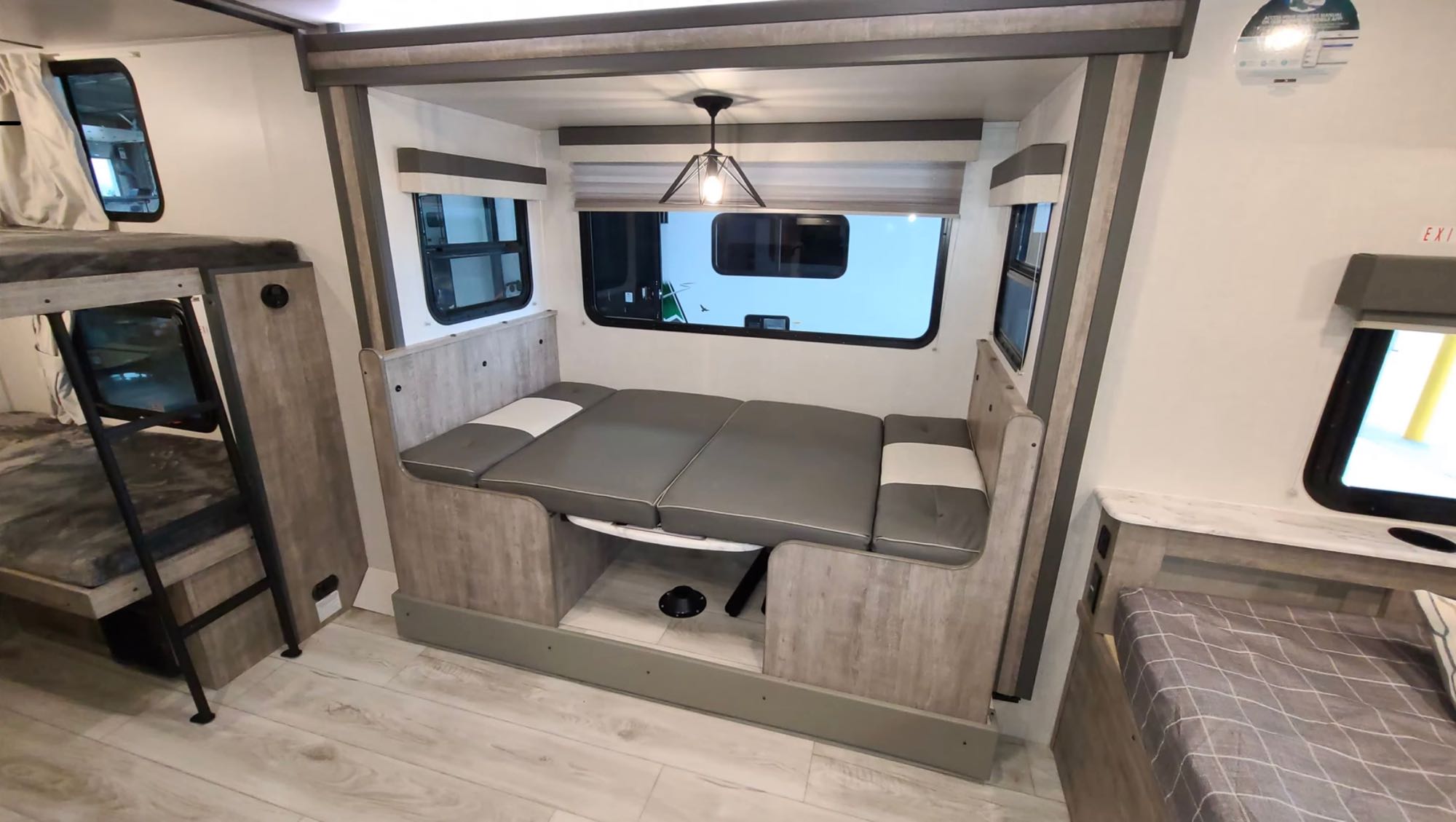Explore this RV rental interior: A versatile dinette converts to a bed, plus bunk beds & extra sleeping space.. Forest River Surveyor Legend 2023