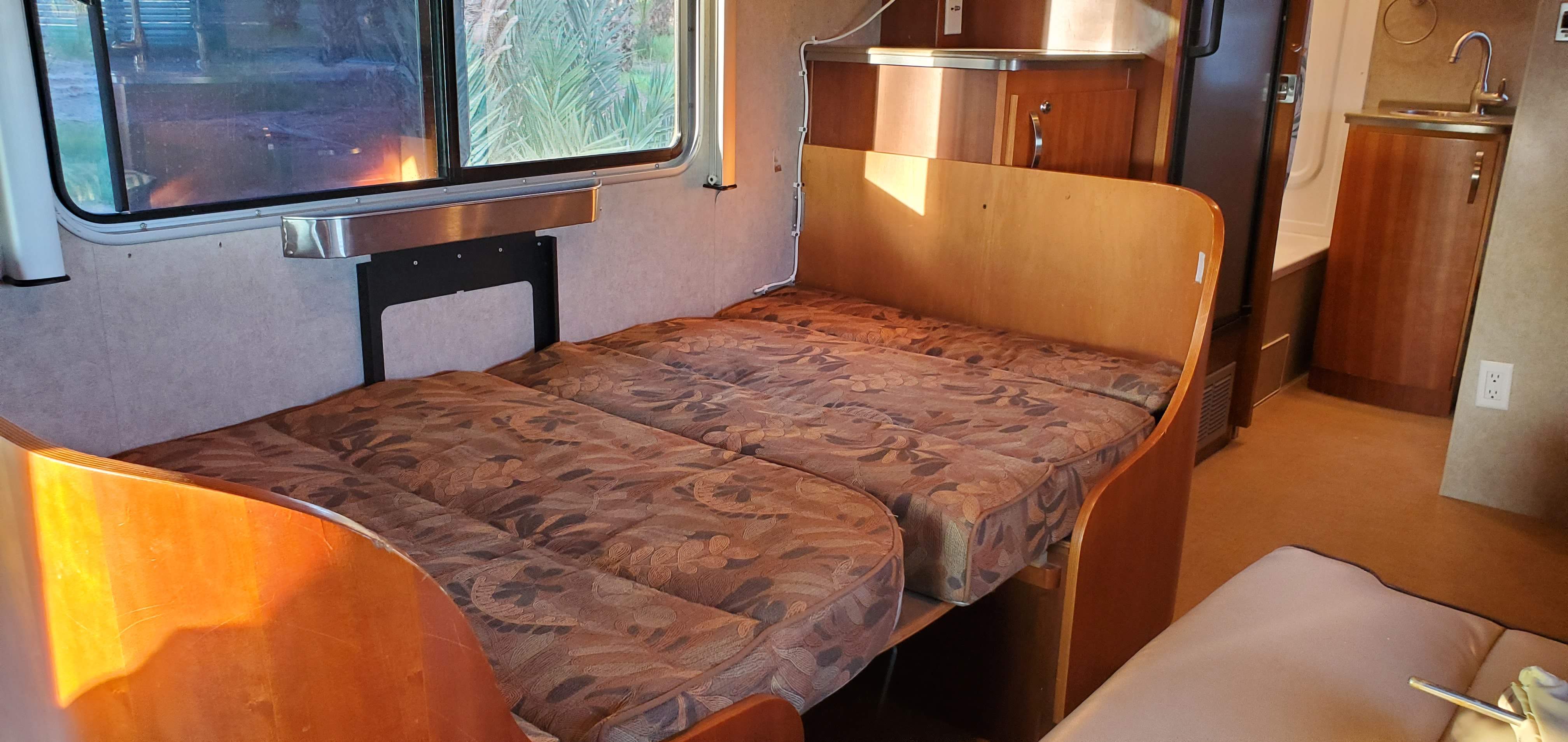 Experience comfort in this RV rental interior with a convertible bed/dinette, window views, and a compact kitchen.. Fleetwood Sprinter 2008