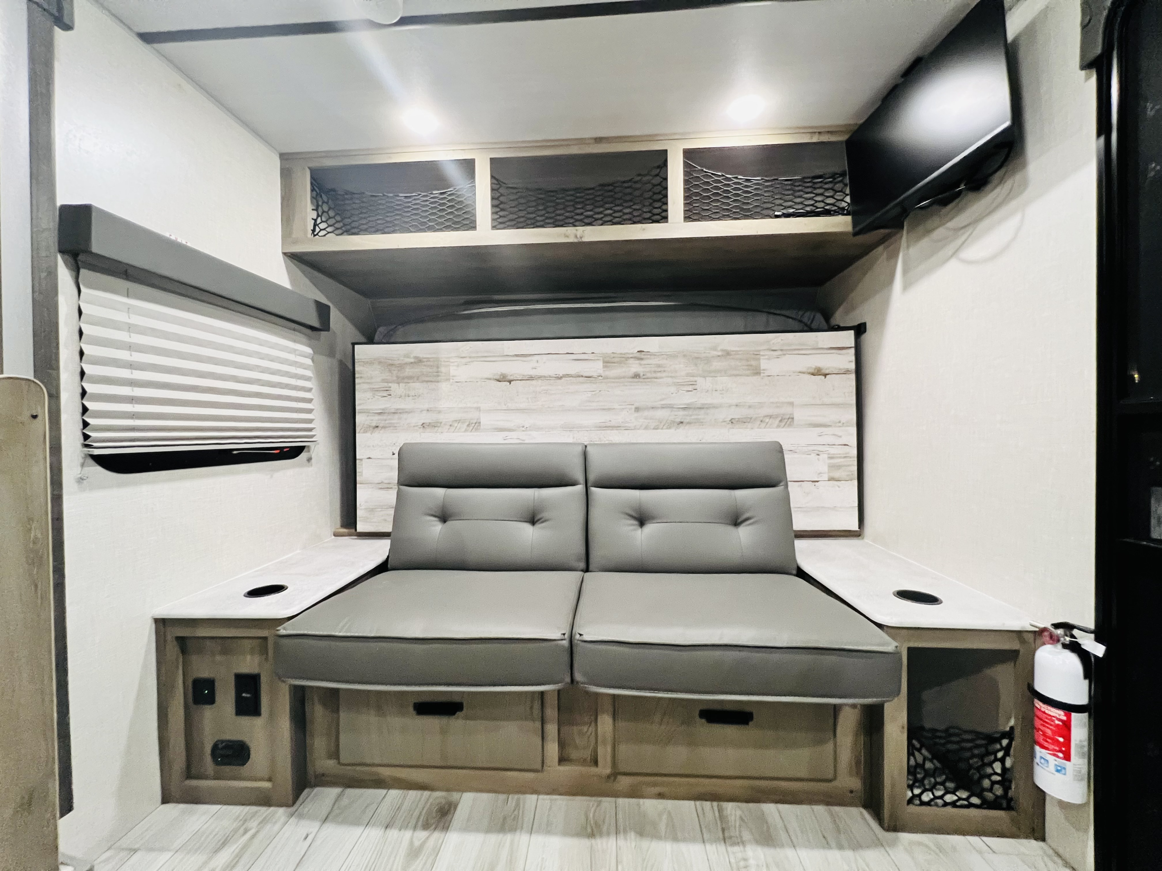 When the queen size Murphy bed is up, you’ll enjoy more seating with the couch and end tables. . Forest River Surveyor Legend 2022