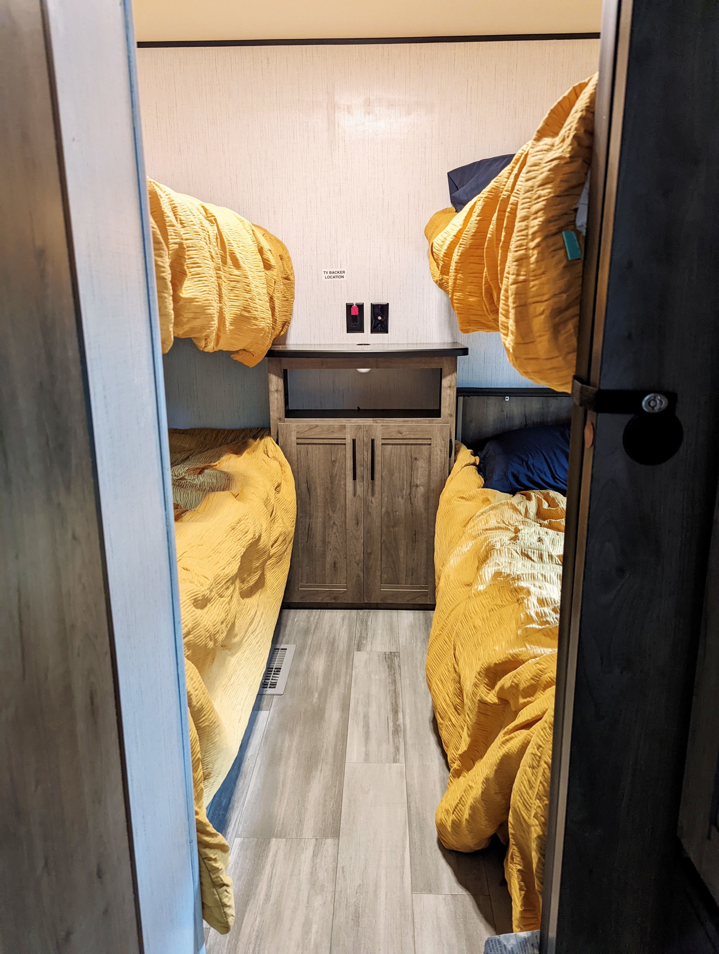 Bright yellow bunk beds furnish this cozy rv rental, complete with a central storage cabinet and TV wall prep.. Heartland RVs Pioneer 2022