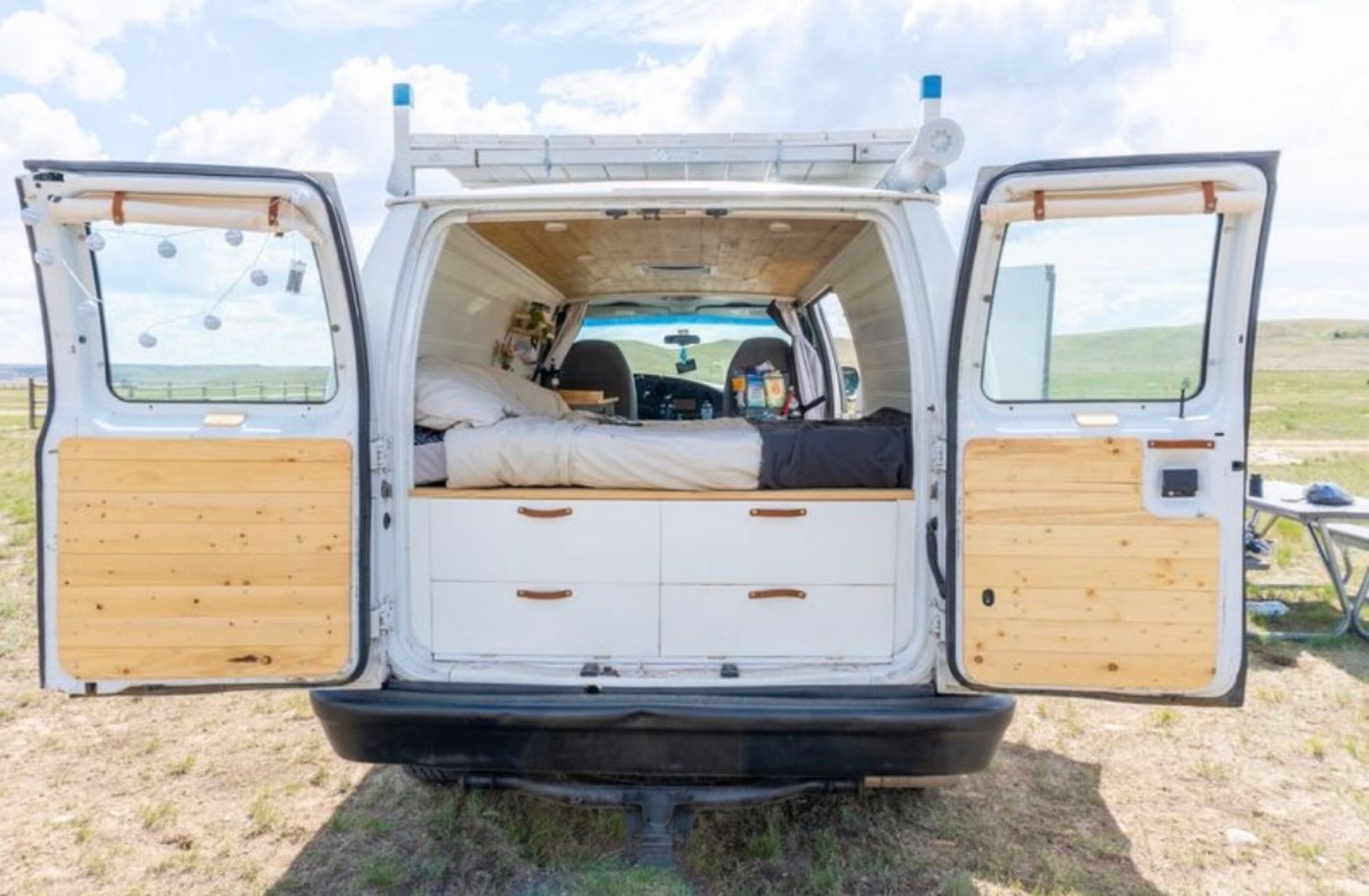 Explore van life! This converted camper van features a bed, drawers & wooden interior, perfect for an rv rental adventure.. Ford Econolline 250s 2008