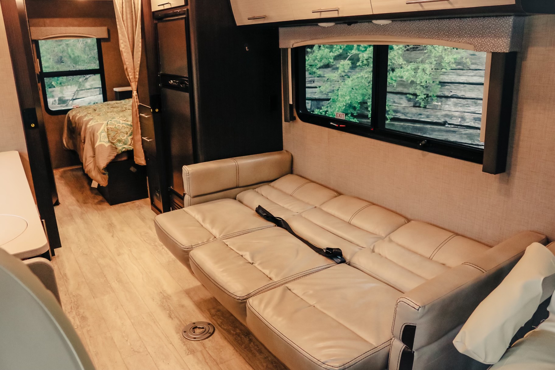 Spacious RV rental interior with a comfy living area and visible bedroom beyond.. Thor Vegas 2018