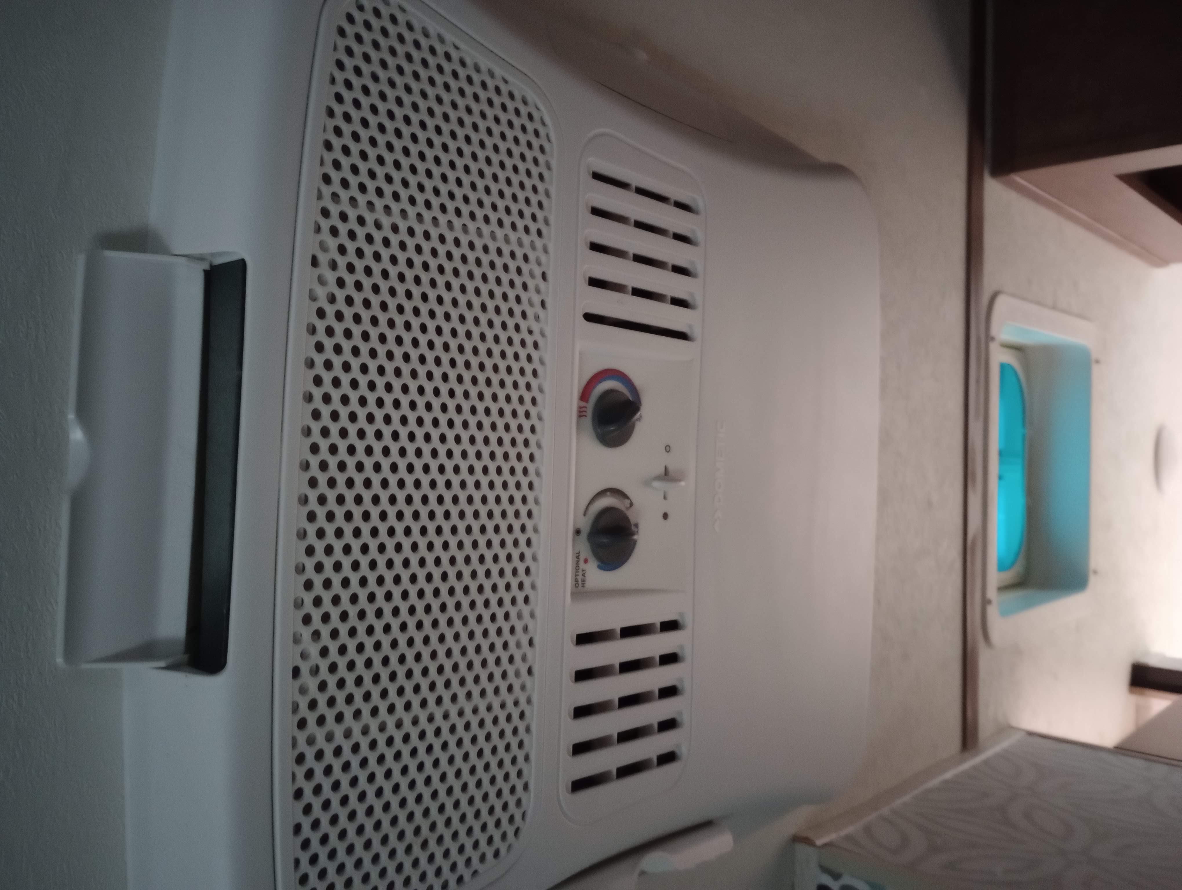 RV rental: Close-up of a white Dometic air conditioner unit with manual controls, providing interior climate comfort.. Starcraft Comet 2018