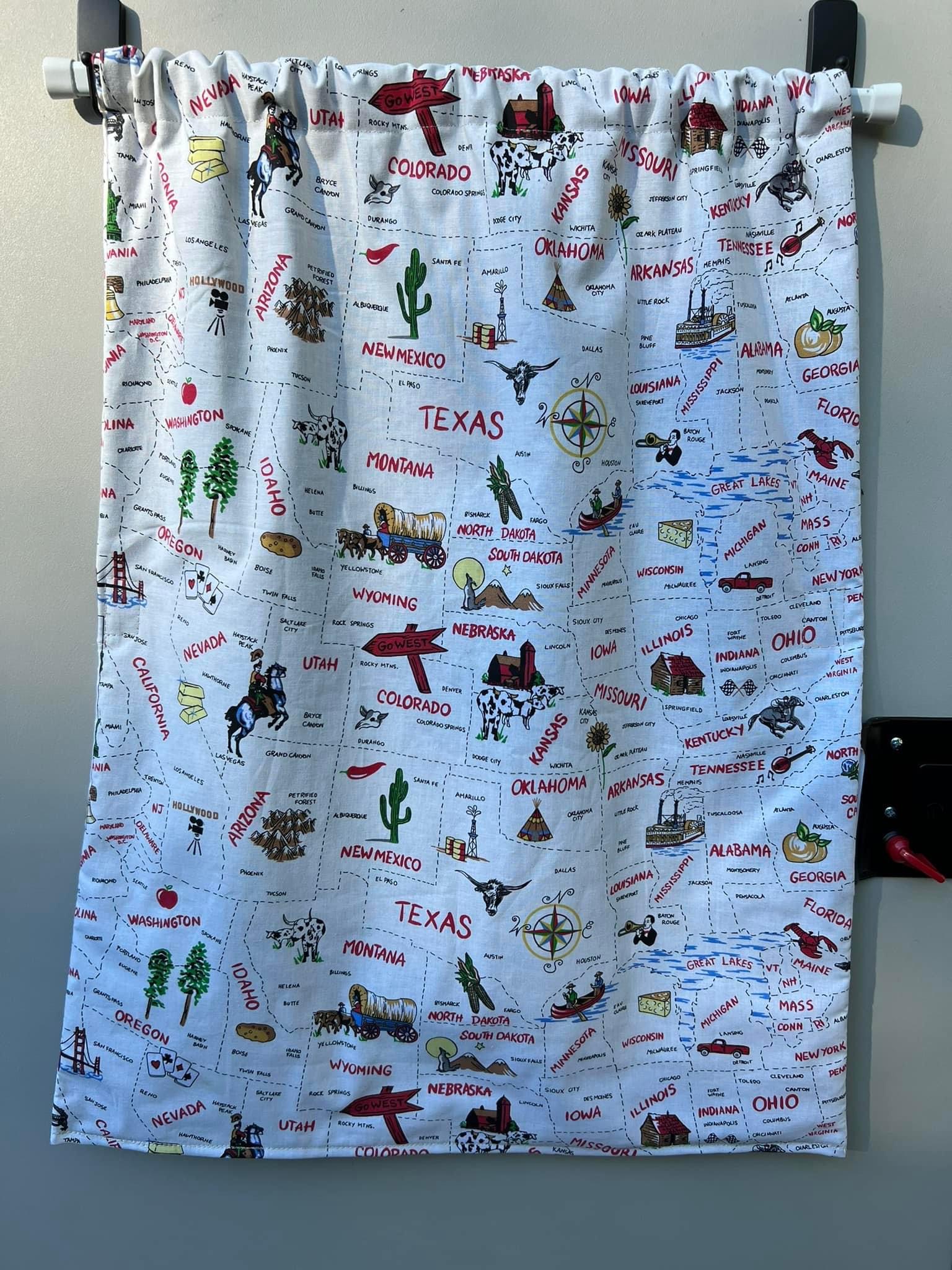 A vibrant fabric curtain displaying an illustrated US map with states & landmarks, a charming addition for an RV rental.. Braxton Creek Free Solo 2022