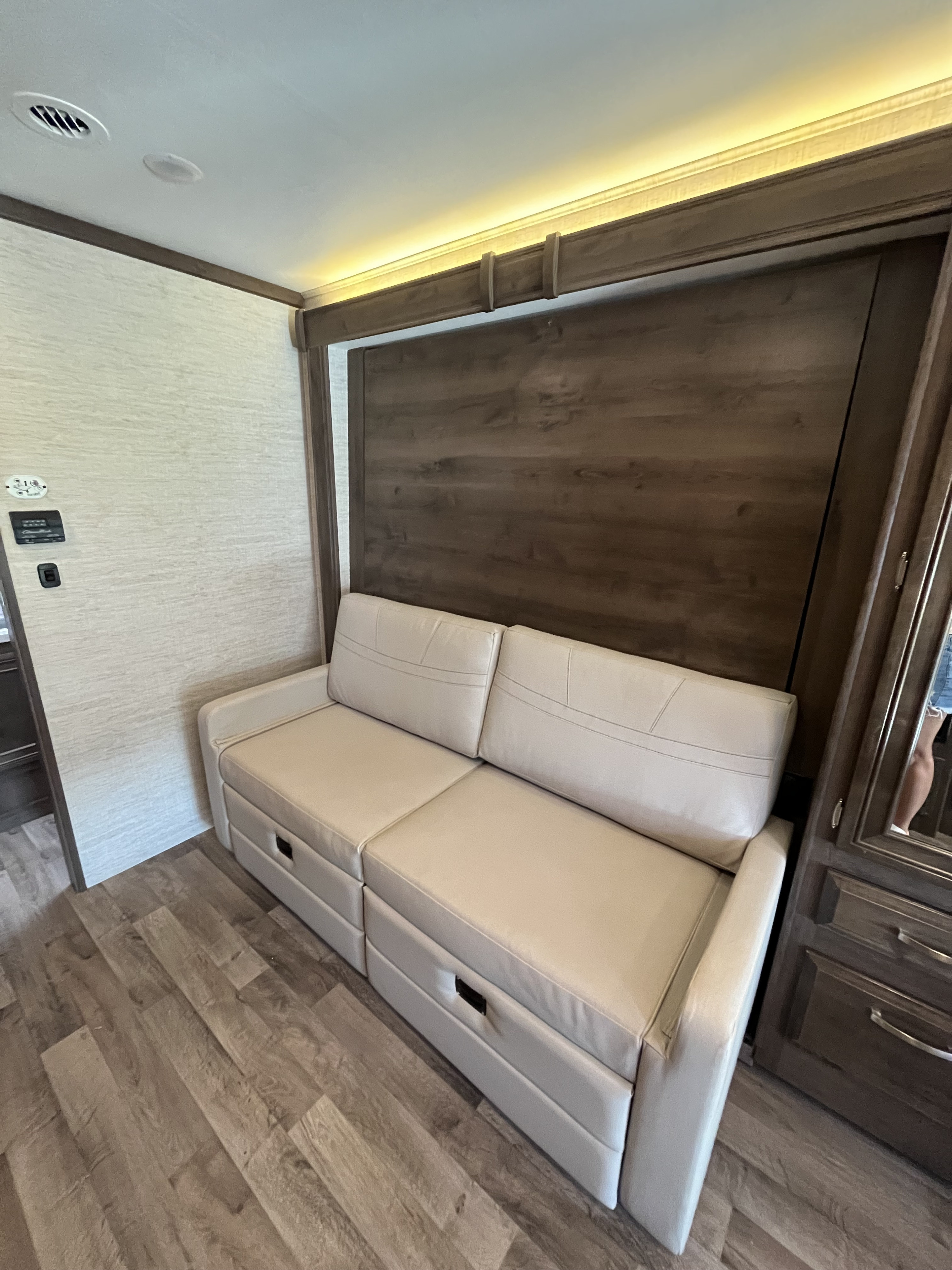 RV rental: Modern interior with a comfortable pull-out sofa, under-seat storage drawers, wood paneling, and ambient lighting.. Jayco Redhawk 2021