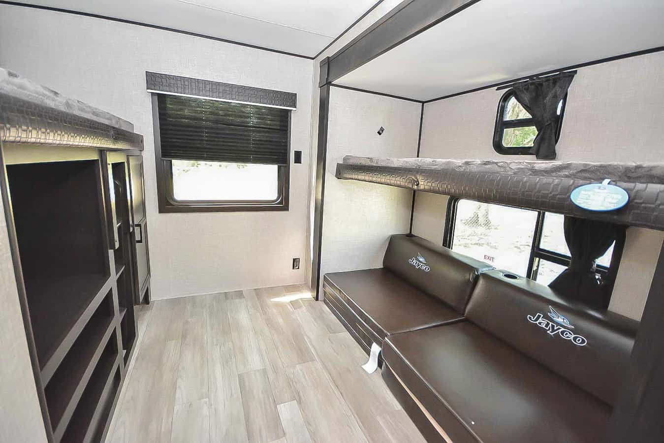 RV rental bunk room shows upper/lower bunks, convertible sofa, window, and storage cabinets.. Jayco Jay Flight 2022