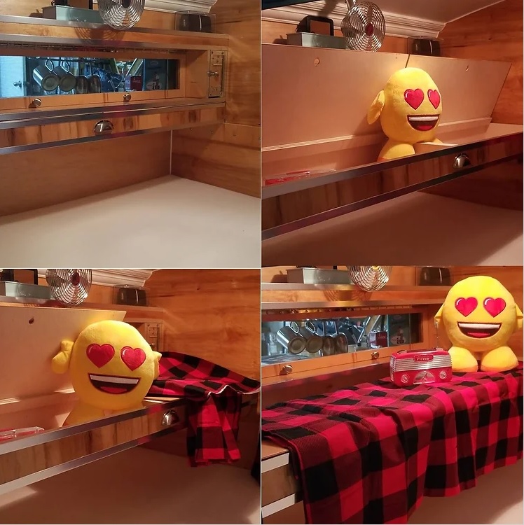 RV rental interior: convertible bunk with storage, kitchen view. Cozy setup with emoji plushie & red plaid blanket.. The Teardrop Trailer Diamond in the rough 2021