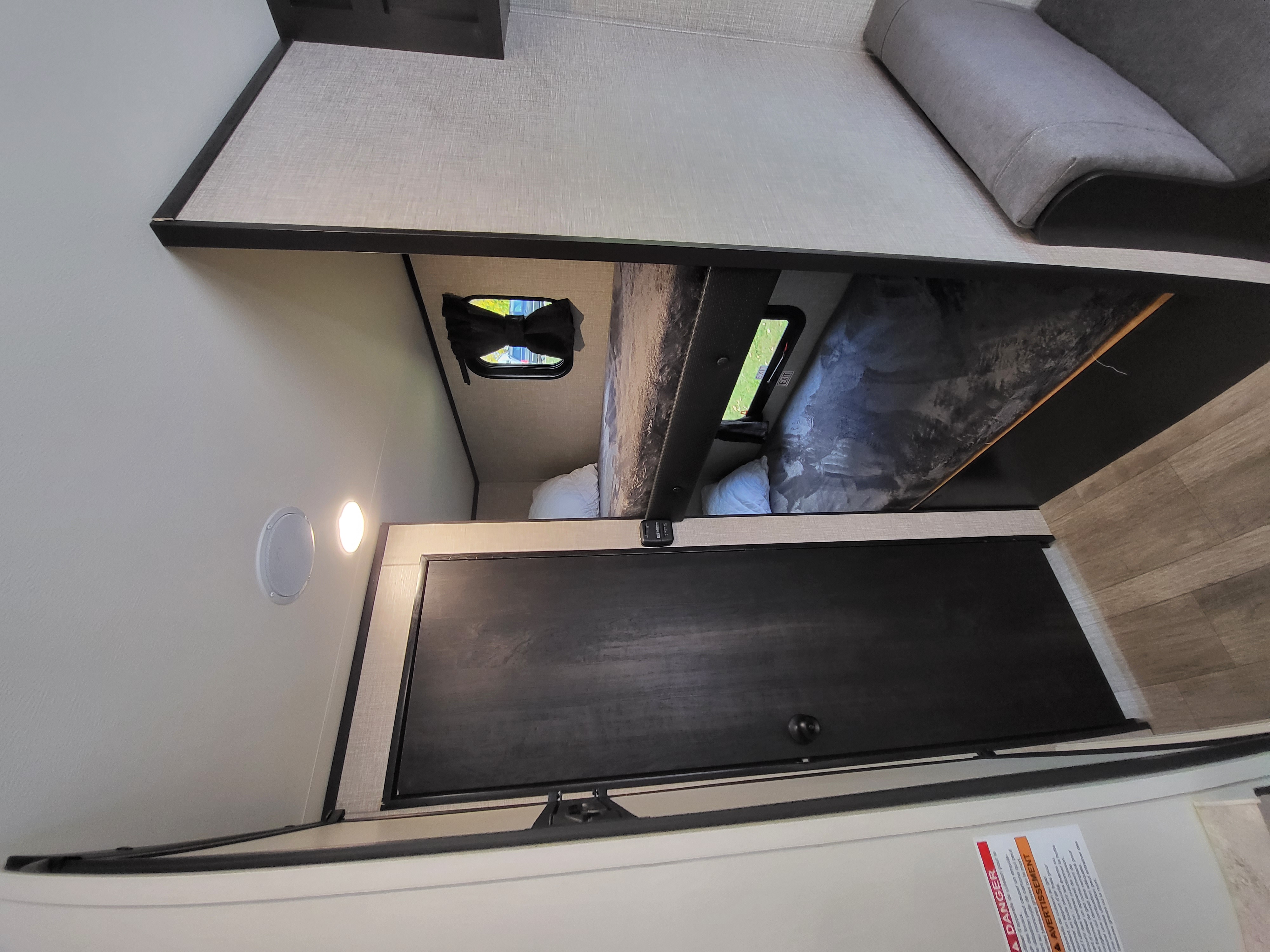 Cozy rv rental interior with bunk beds, windows, and sofa, offering a comfortable travel space.. Jayco Jay Flight SLX 2022