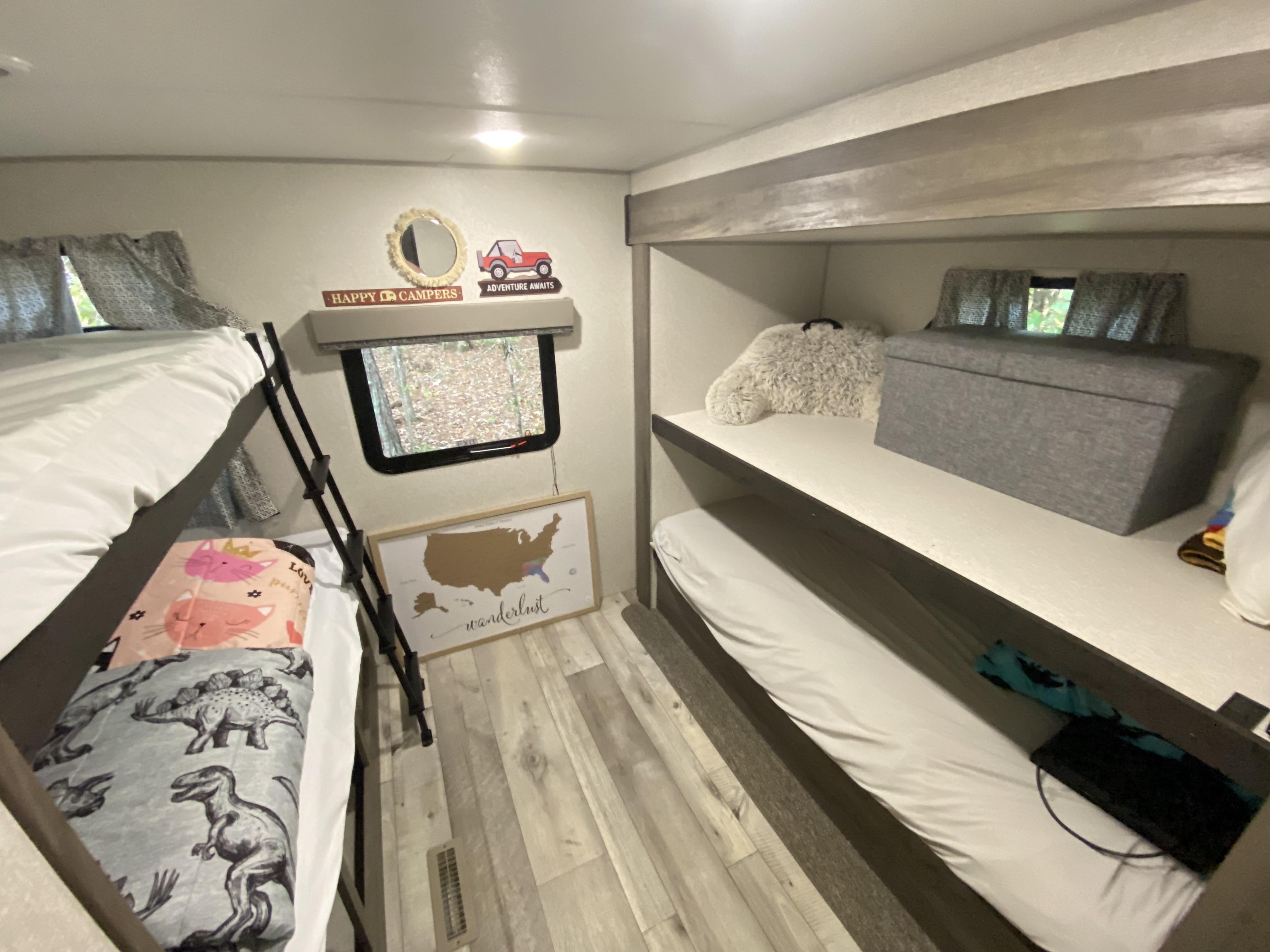 RV rental's bunk room: four cozy beds with themed blankets, adventure decor, and a window view.. Sportsmen SE 2021