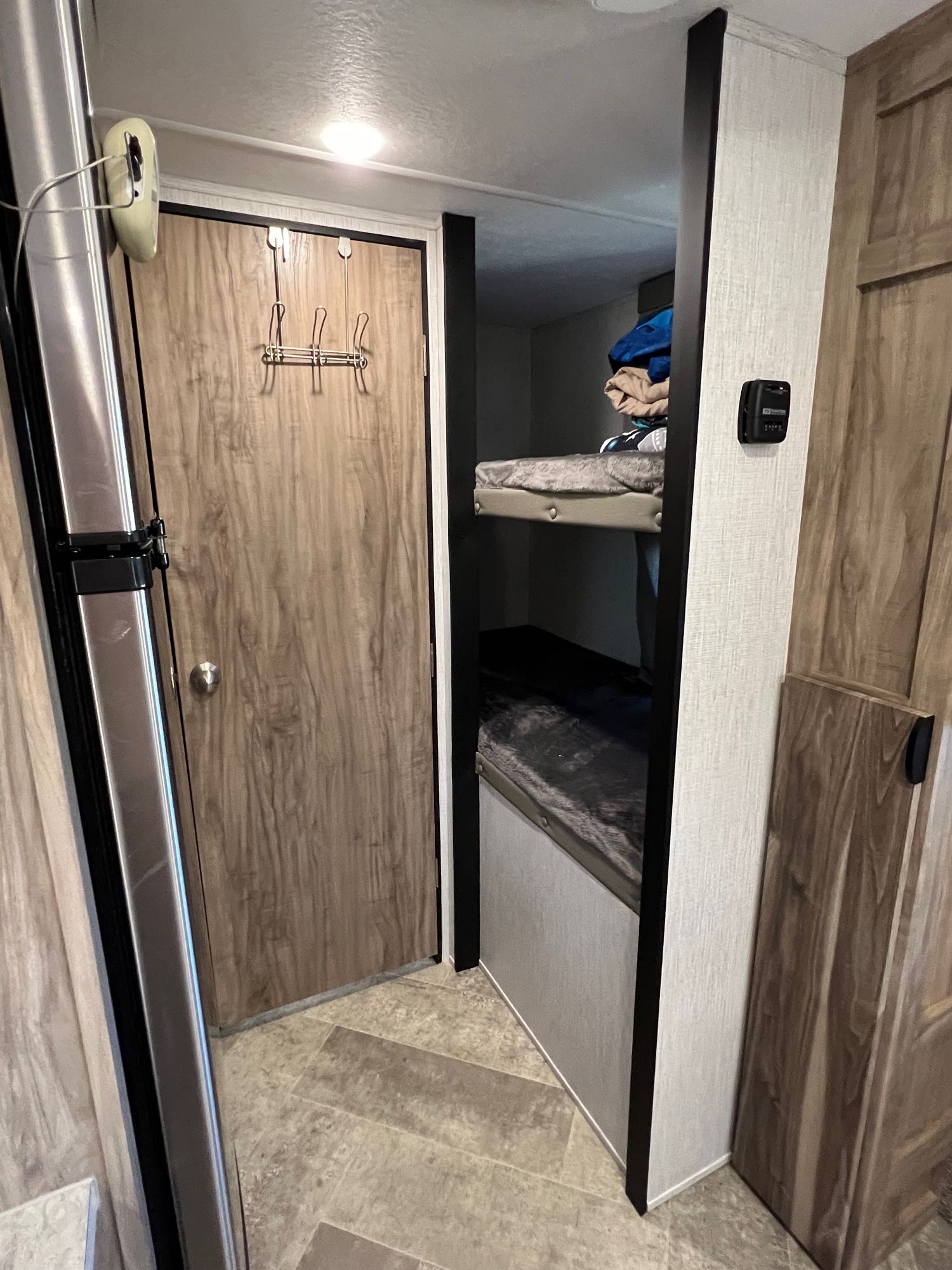 This RV rental features cozy bunk beds, a handy door hook rack, and a refrigerator for comfortable trips.. Palomino Palomini 2022