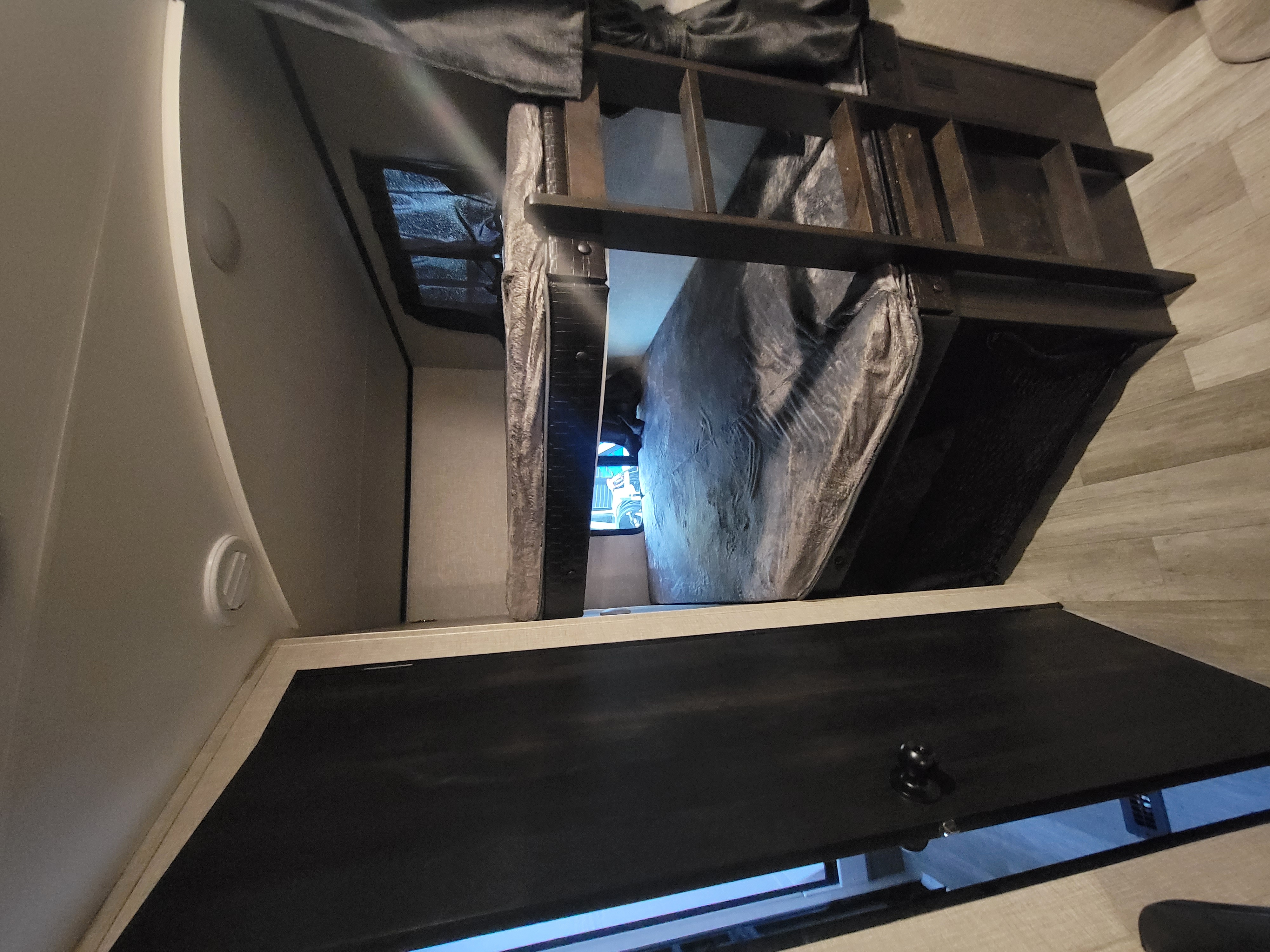 Inside this RV rental, discover compact bunk beds, with one mattress covered, and a small window. Ideal camper sleeping.. Jayco Jay Feather 2022