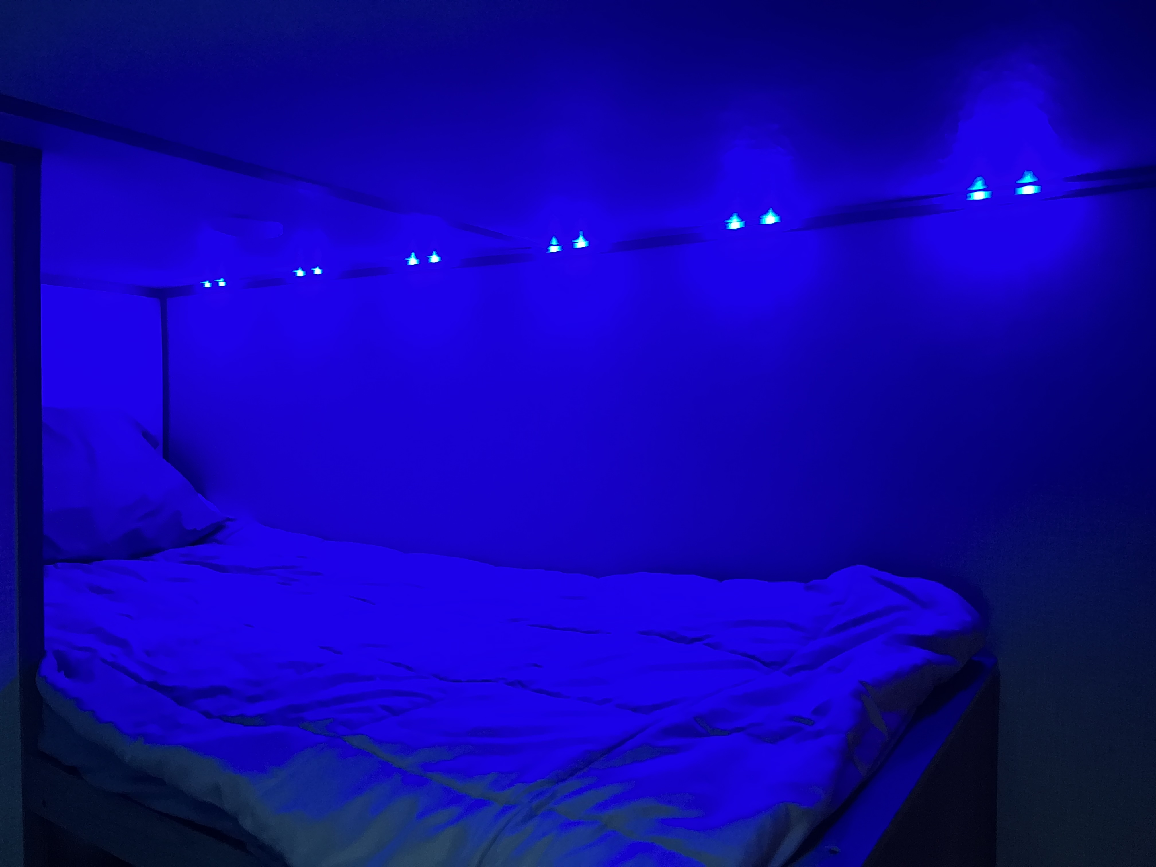 Cozy RV rental bunk with vibrant blue LED lighting creates a tranquil sleeping space.. Dutchmen 17B 2022