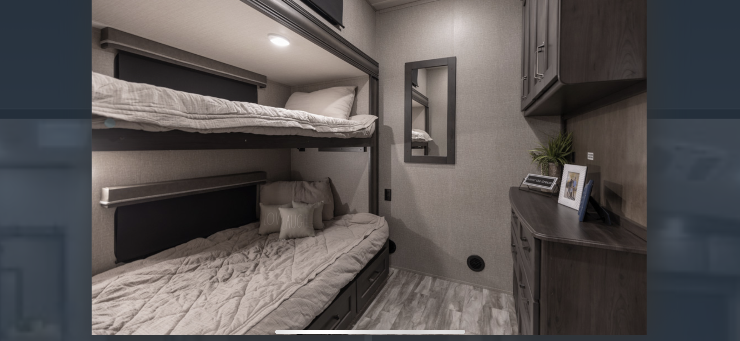 RV rental: Cozy bunk bed setup with two beds, storage, mirror, and decor, perfect for travel.. Grand Design Reflection 2022
