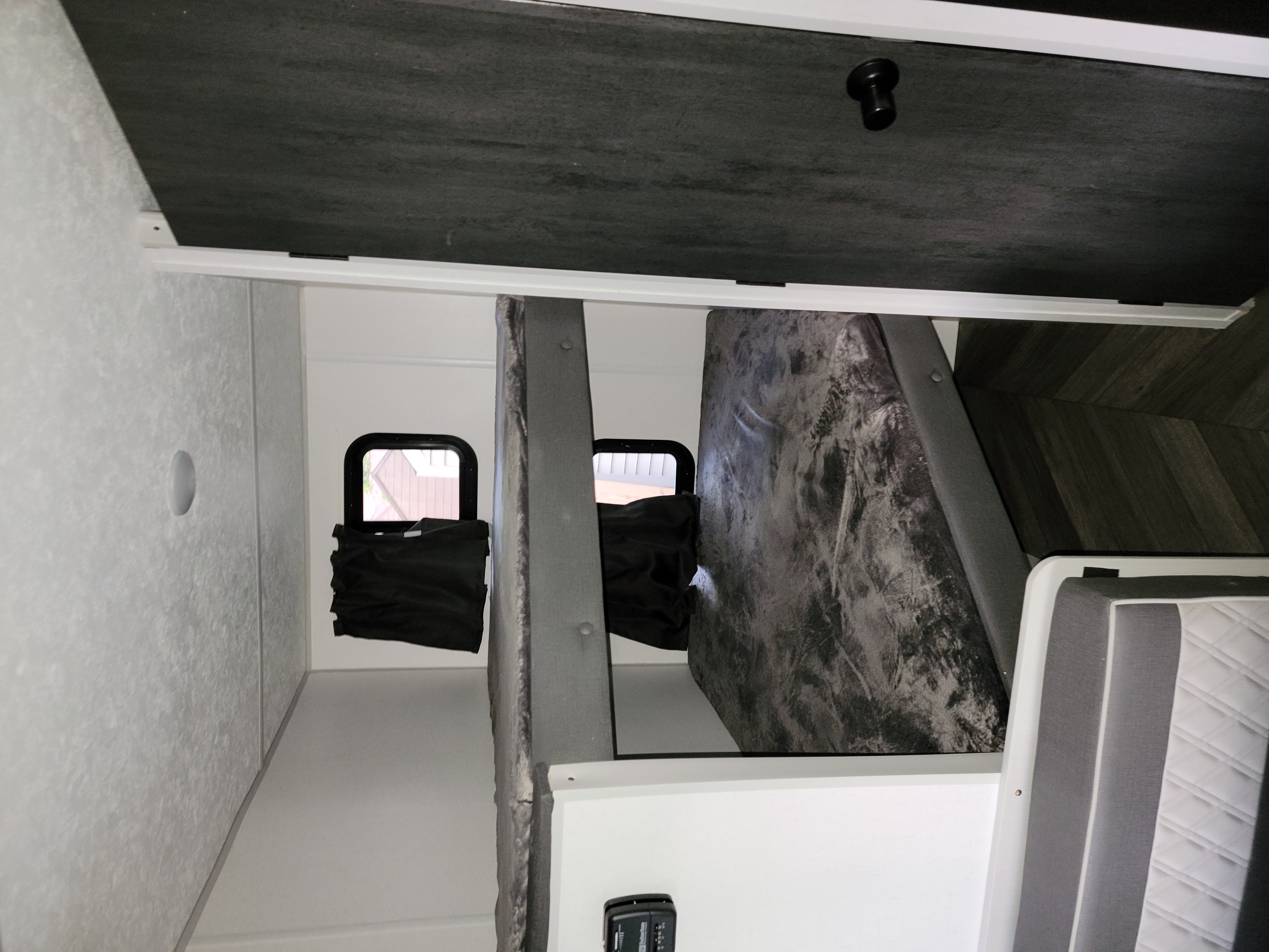 RV rental interior: View of the sleeping area with bunk beds, mattresses, and shaded windows, showcasing a functional layout.. Forest River Salem FSX 2021