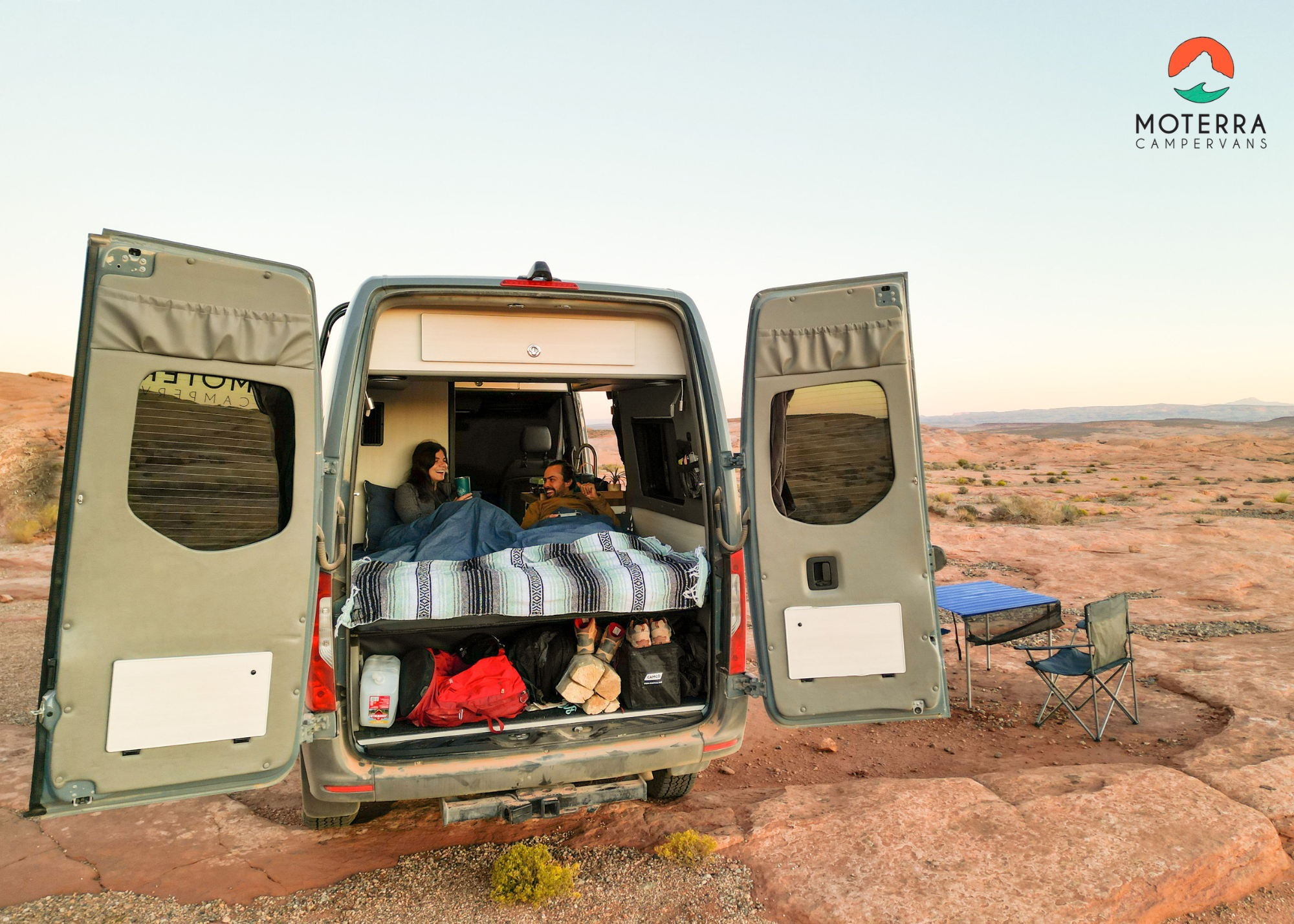 RV rental adventure: Couple cozy in their campervan with open doors, enjoying the scenic desert outdoors.. Mercedes-Benz Sprinter 2020