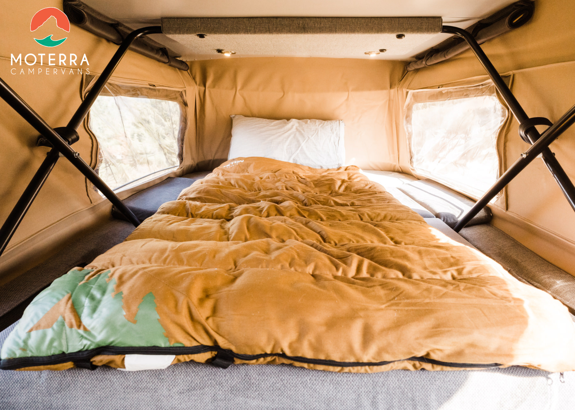 Inside a spacious Moterra RV rental pop-top tent, a comfy bed with a sleeping bag awaits your next adventure. Ideal for travel.. Mercedes-Benz Sprinter 2020