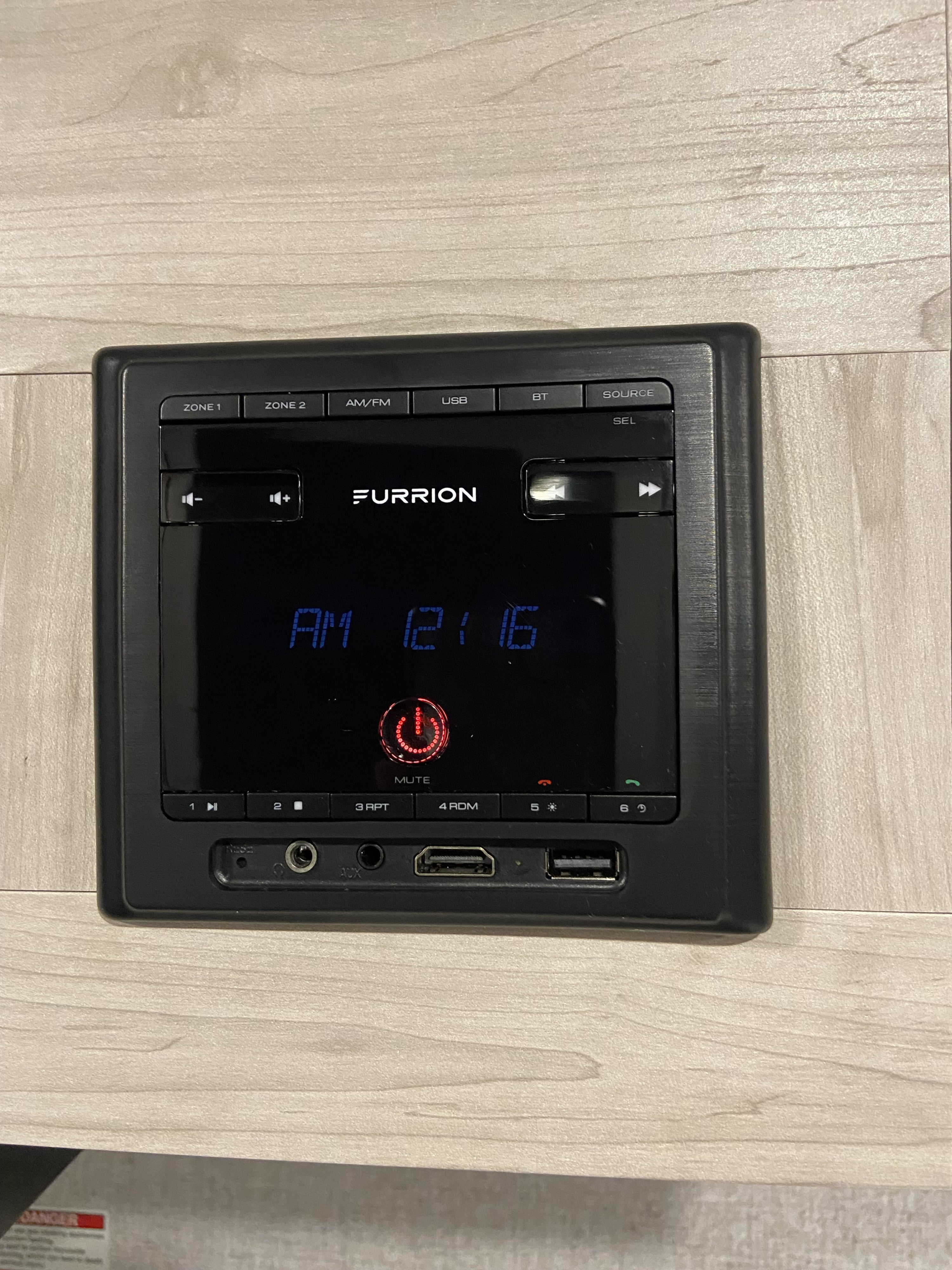 Furrion audio system control panel in an rv rental. Displays AM 12:16; features AM/FM, USB, BT, AUX, HDMI, and volume.. East to West Silver Lake 2022