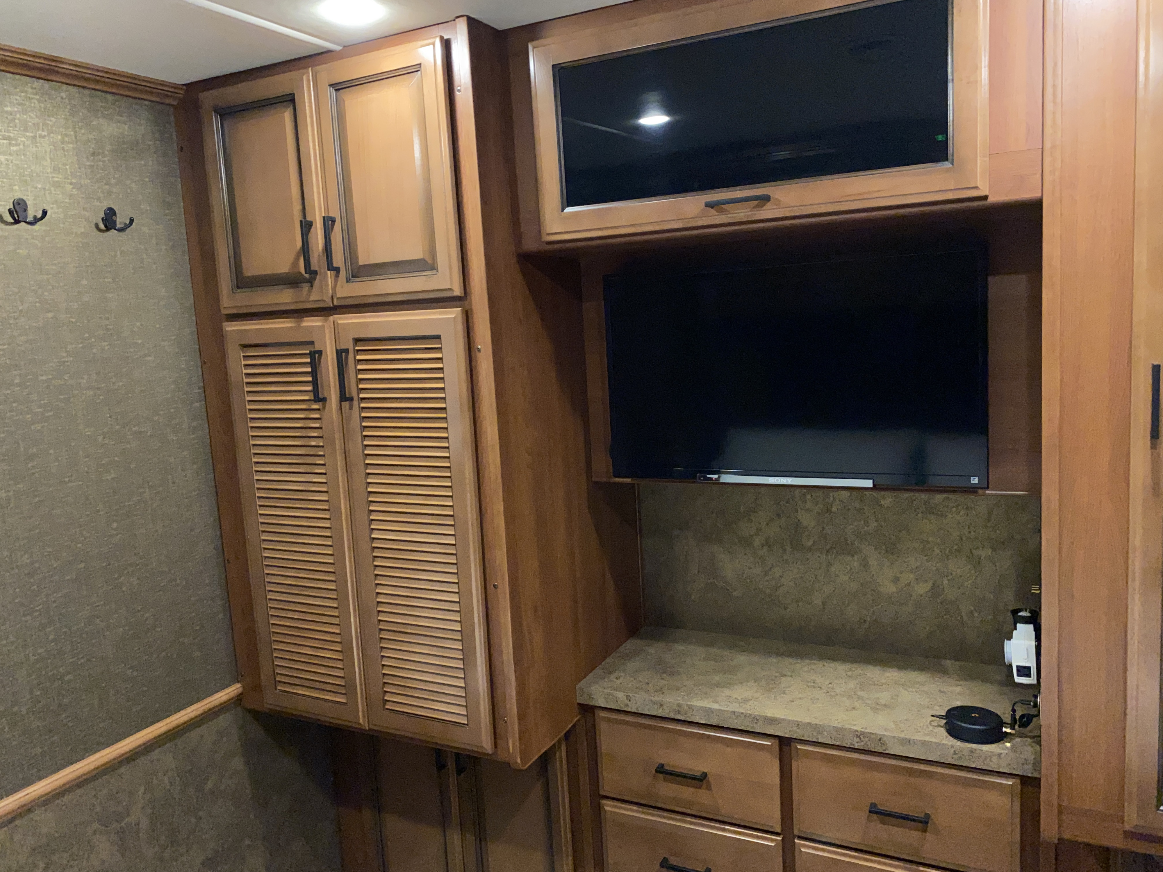 This RV rental offers a well-appointed interior with warm wood cabinets, dual TVs, and practical storage, ideal for travel.. Fleetwood Bounder 33C 2014